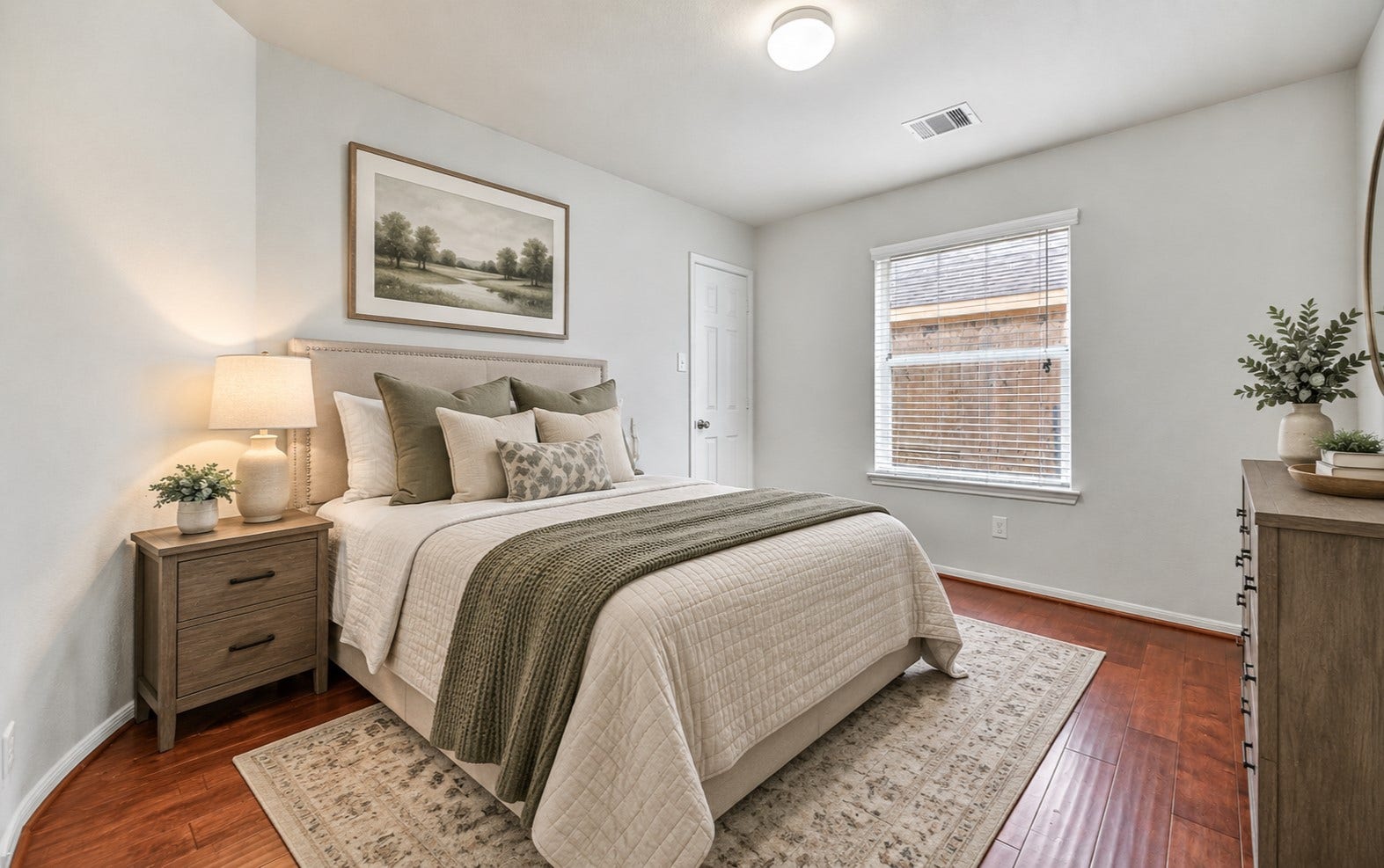 318 Lake Line Drive, Alvin, TX 77511 One of three secondary bedrooms offers fresh neutral paint, warm wood flooring, a large window with 2" blinds & a generous walk-in closet, continuing the home's clean, move-in ready feel. (virtually staged)