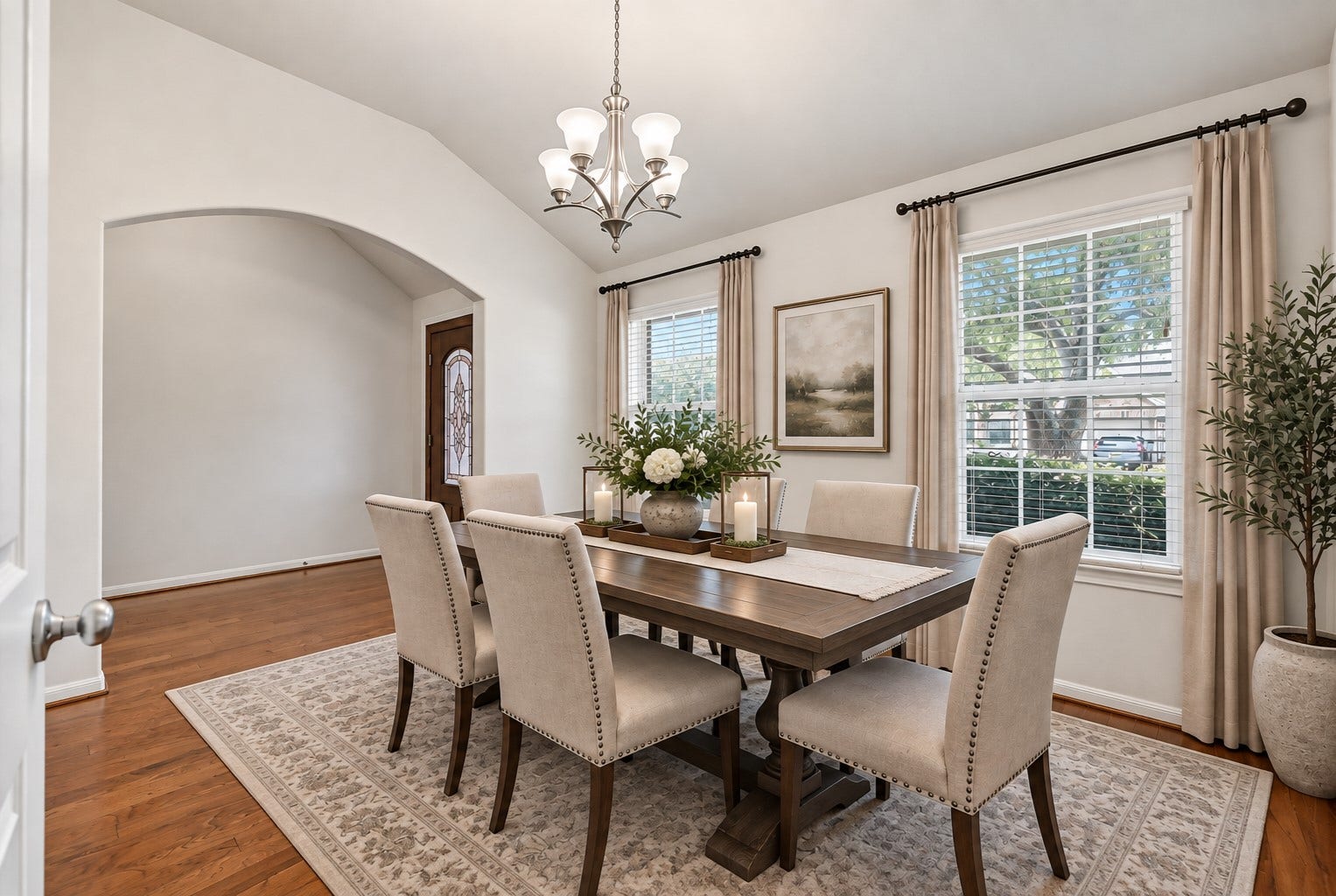 318 Lake Line Drive, Alvin, TX 77511 Just off the entry, the spacious formal dining room boasts a dramatic vaulted ceiling, warm wood flooring, fresh neutral paint & a contemporary chrome-finish chandelier, with an oversized arched opening creating an open connection to the foyer. (virtually staged)