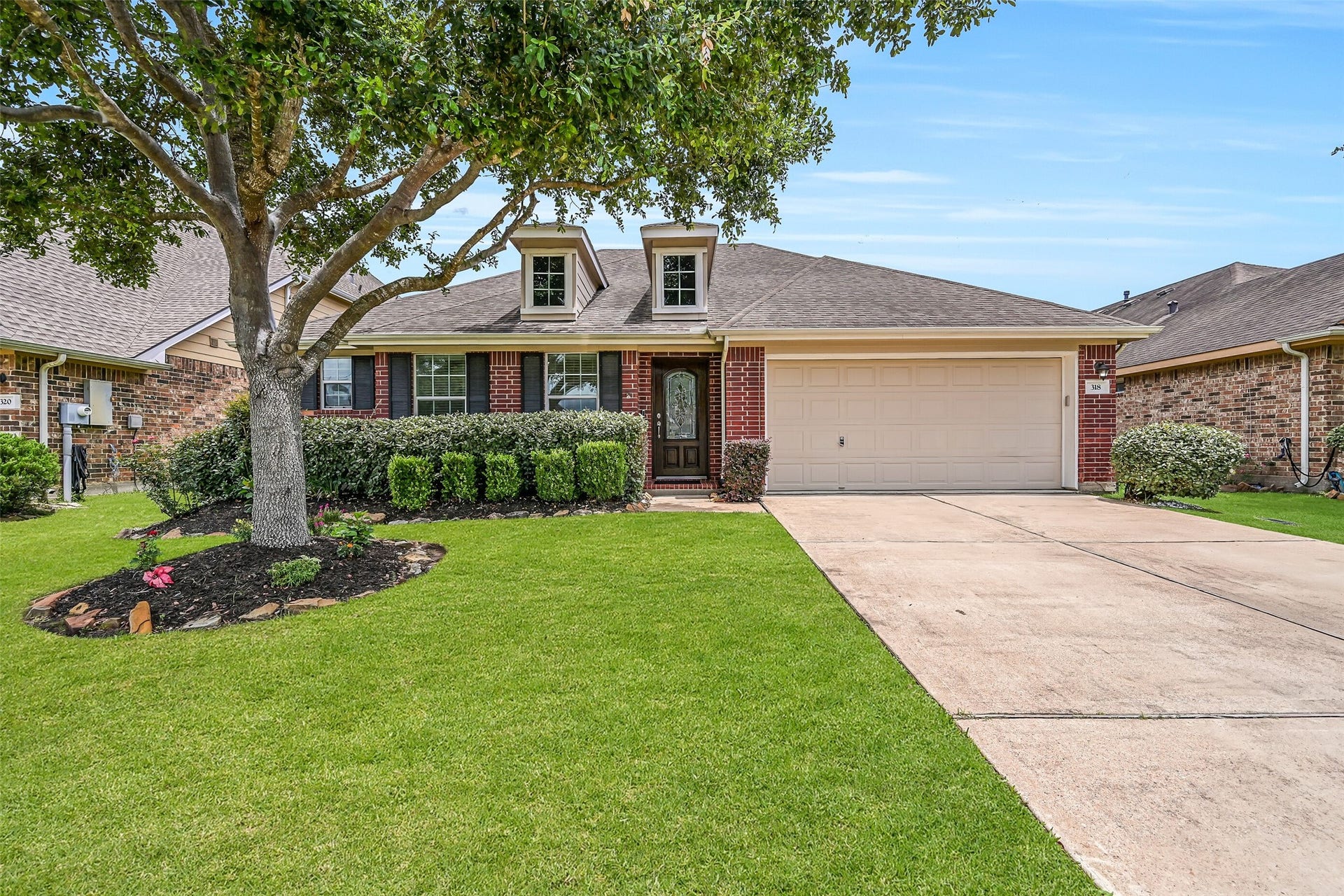 318 Lake Line Drive, Alvin, TX 77511 Welcome to 318 Lake Line Drive in Alvin's Kendall Lakes! This charming single-story brick home features mature landscaping, a double-wide driveway, 2-car attached garage & distinctive dormer windows, all framed by a beautiful mature shade tree.