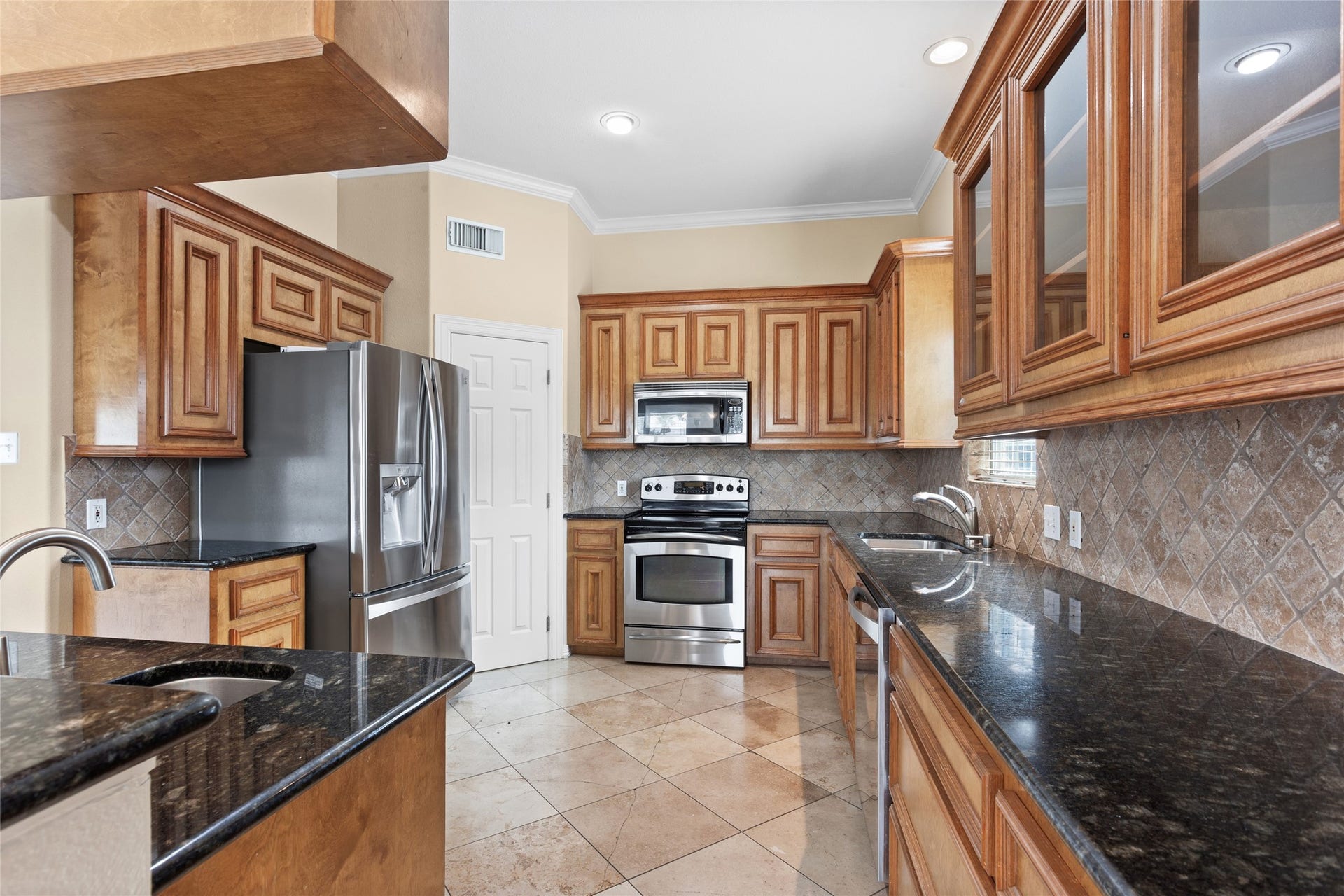 1110 Papeete Street, Tiki Island, TX 77554 Second floor kitchen with stainless steel appliances