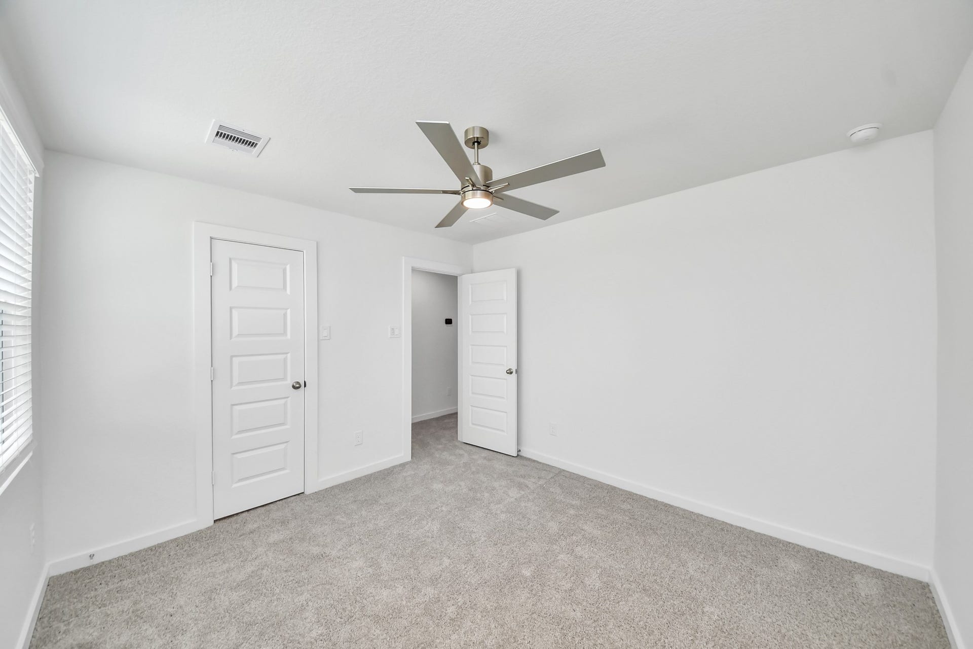 Generously sized secondary bedrooms featuring spacious closets, soft and inviting carpeting underfoot, large windows allowing plenty of natural light, and the added touch of privacy blinds for your personal retreat. Sample photo of completed home with similar floor plan. Actual colors and selections may vary.