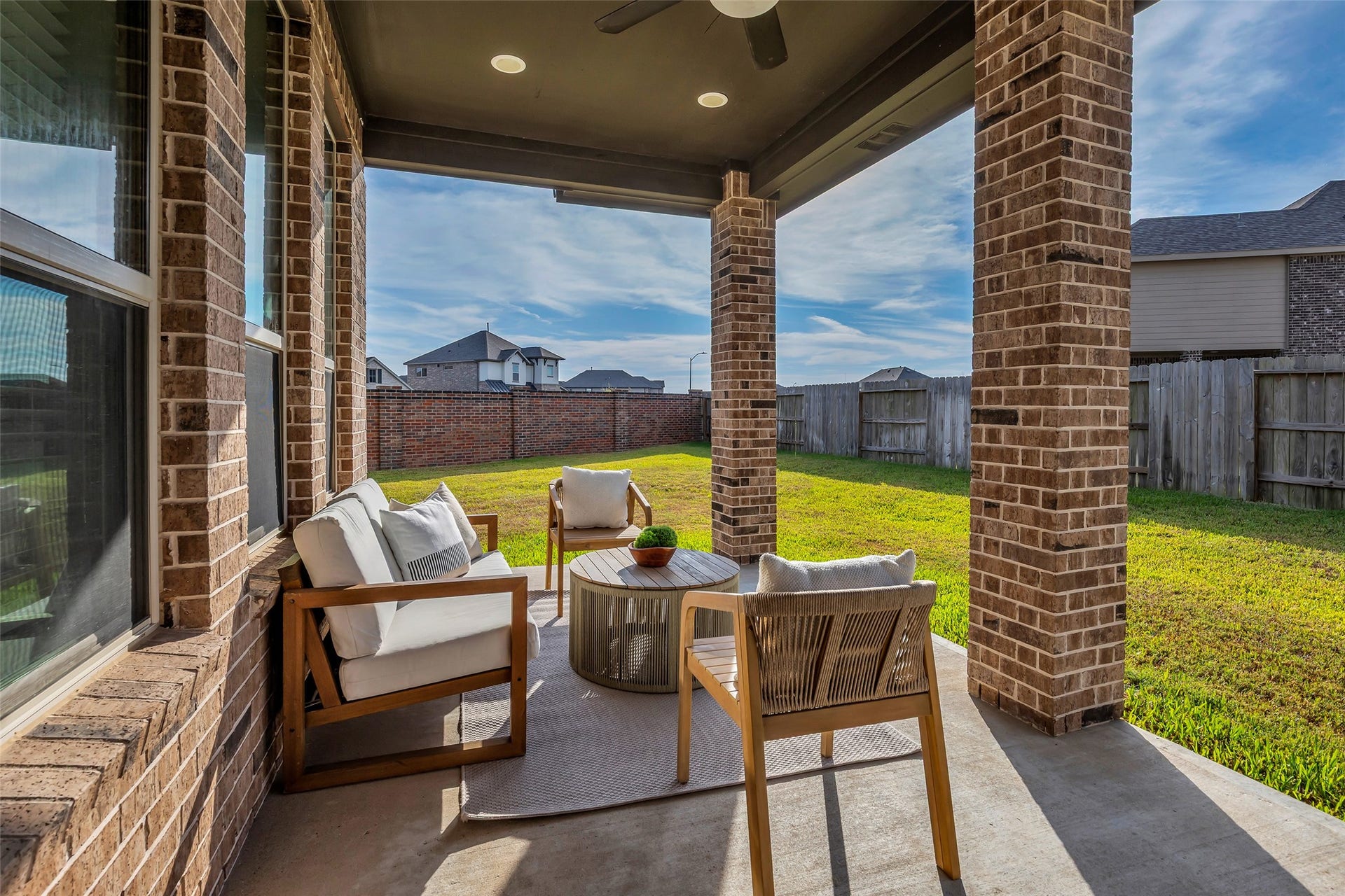 801 Bahia Bay Drive, Katy, TX 77493 This spacious covered patio features a ceiling fan and ample room for customization, offering the perfect foundation to design your own custom summer kitchen.