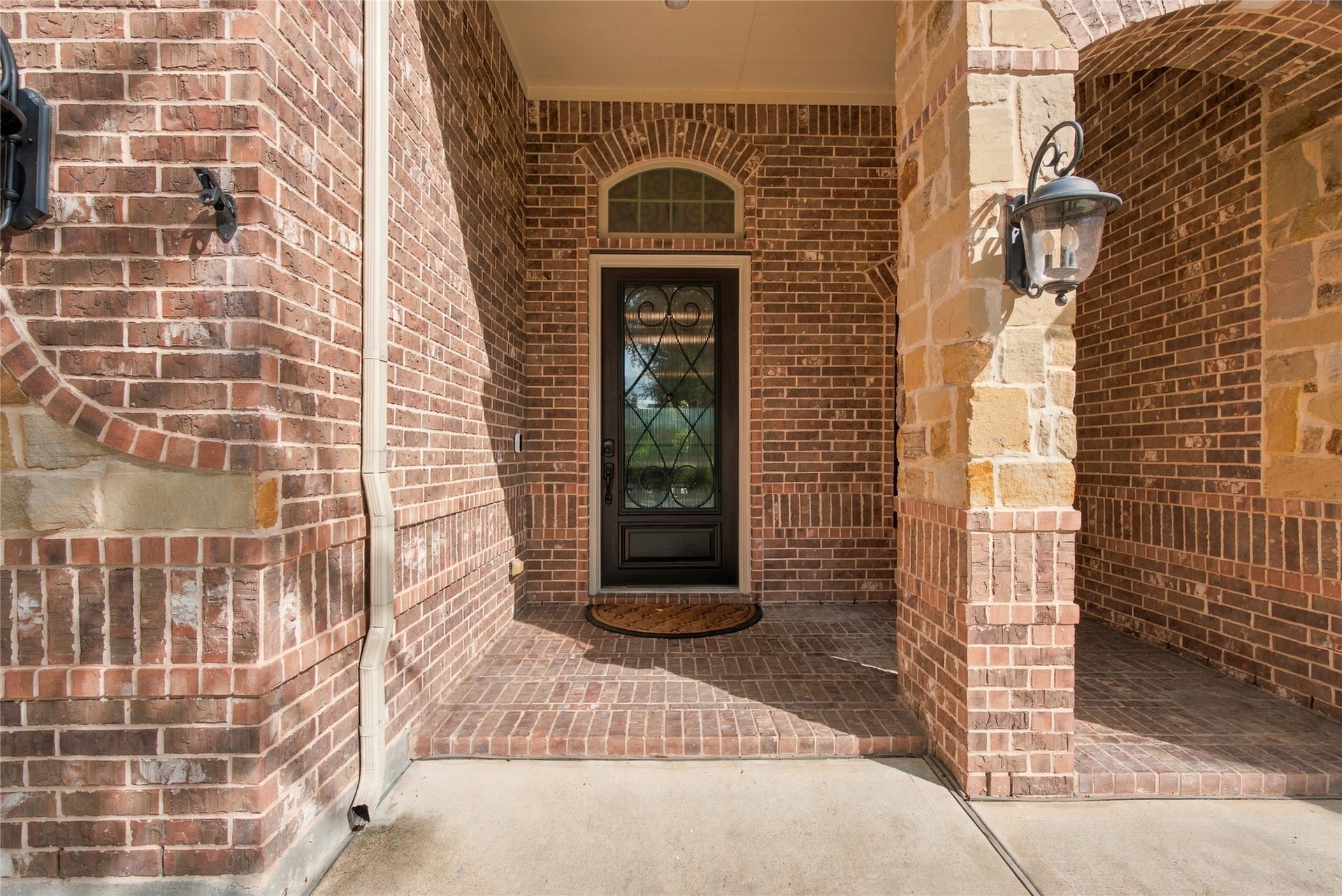 19215 Shady Blossom Drive, Cypress, TX 77433 Welcoming covered front porch with charming brick detailing and an inviting entryway.