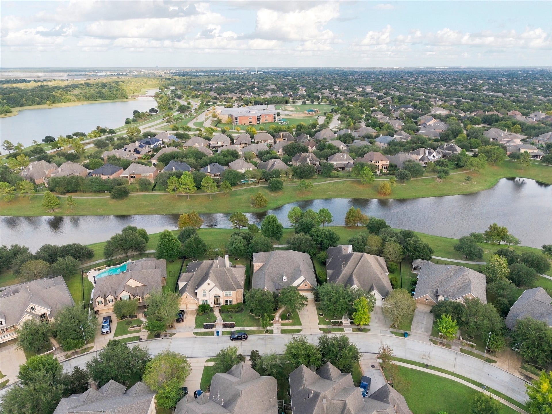 19215 Shady Blossom Drive, Cypress, TX 77433 Phenomenal aerial view showcasing the home's waterfront location and the scenic surroundings of Water Haven at Bridgeland.
