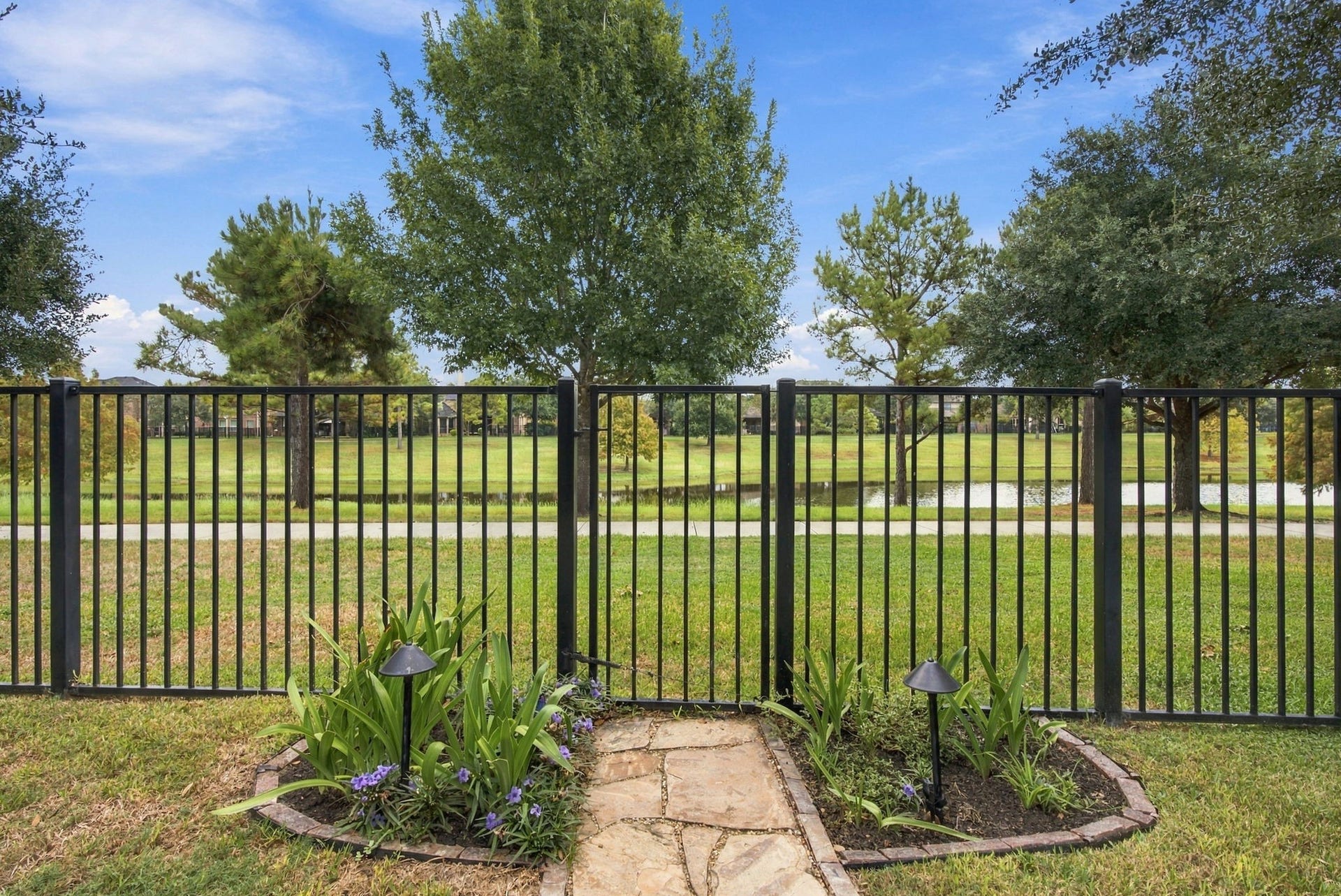 19215 Shady Blossom Drive, Cypress, TX 77433 Peaceful water views surrounded by mature trees and lush green space, with a walking trail just beyond the backyard.
