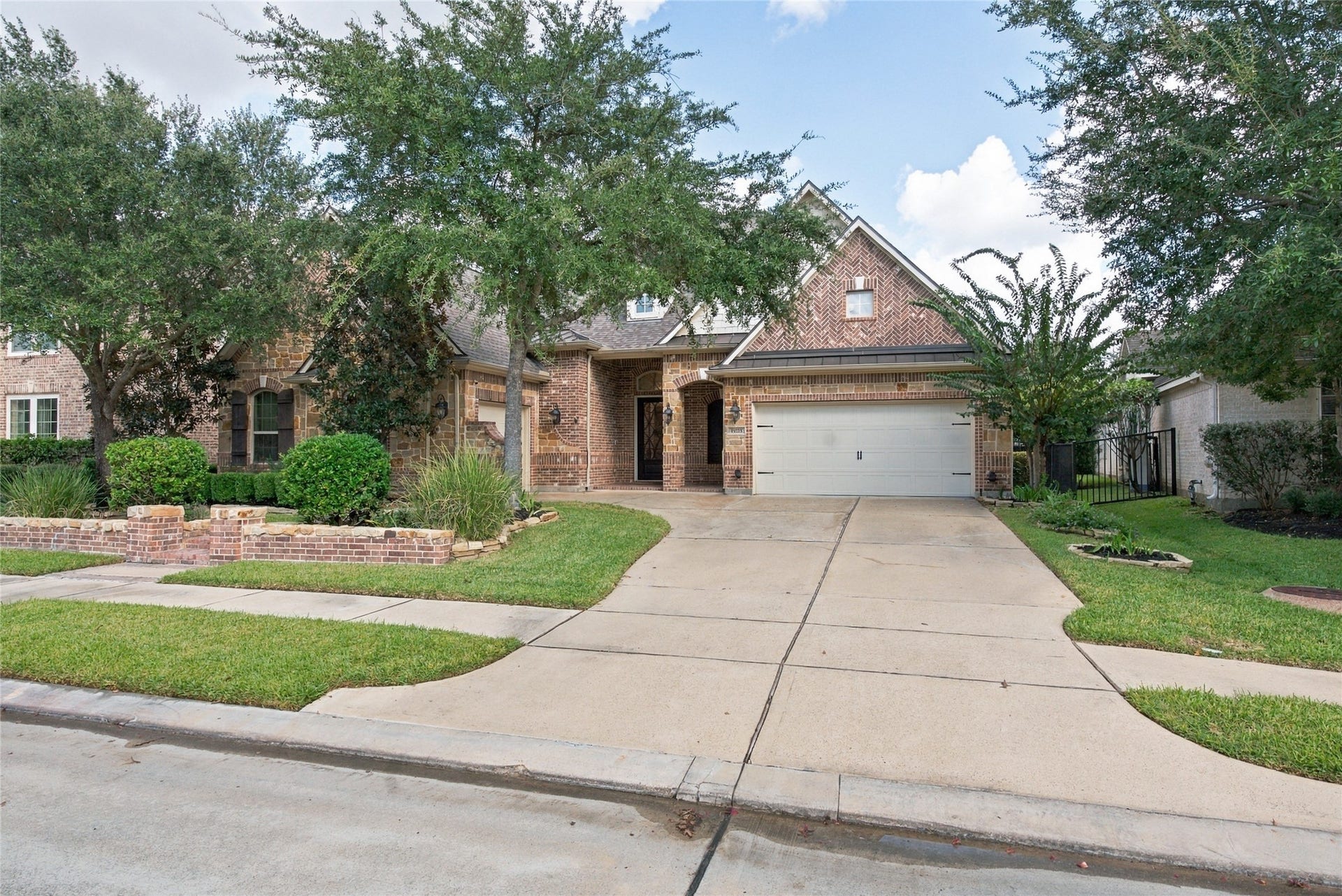19215 Shady Blossom Drive, Cypress, TX 77433 This home offers charming curb appeal with mature trees and beautifully maintained landscaping.