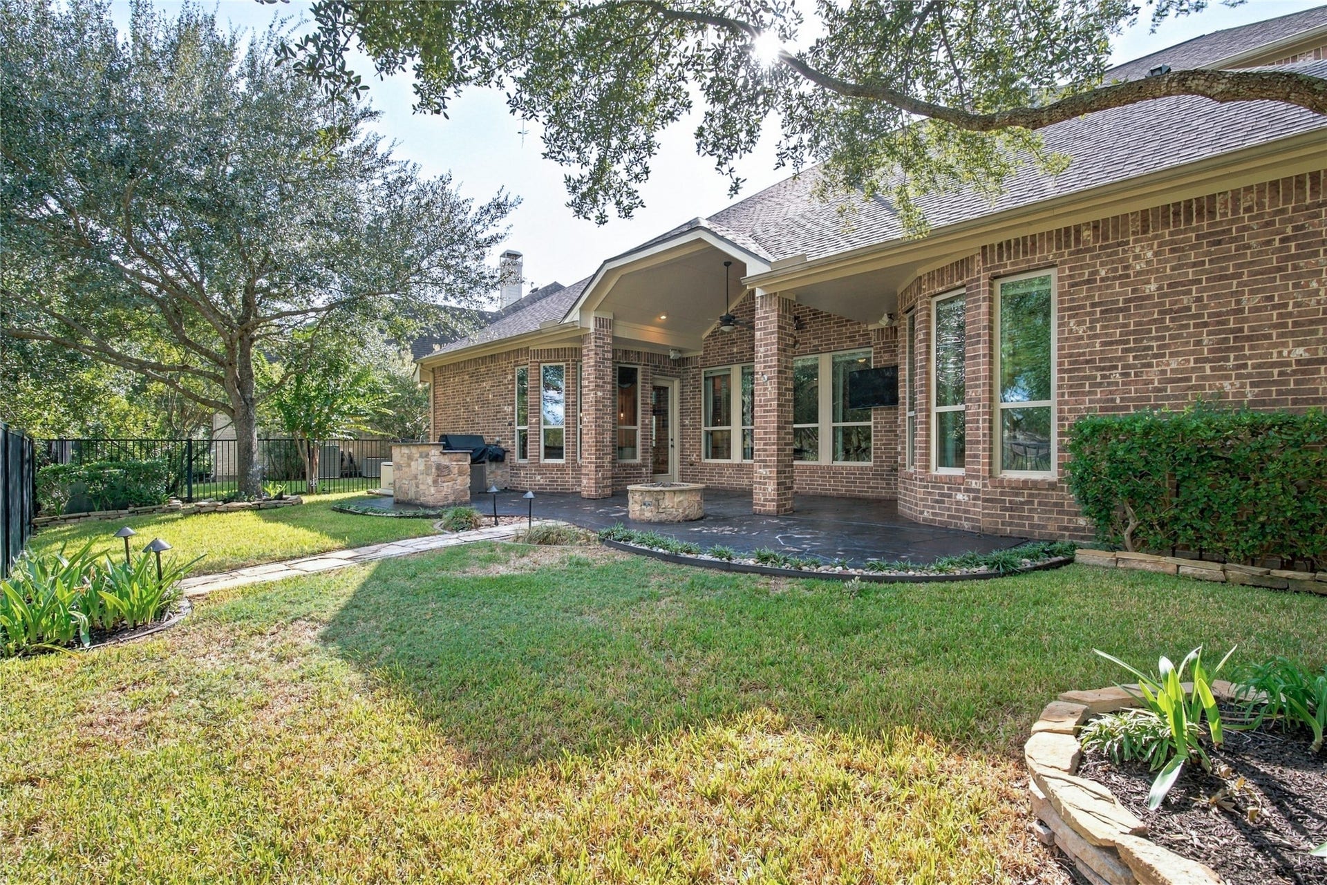 19215 Shady Blossom Drive, Cypress, TX 77433 Enjoy outdoor living with an extended patio, outdoor kitchen, and beautifully landscaped backyard overlooking the water.