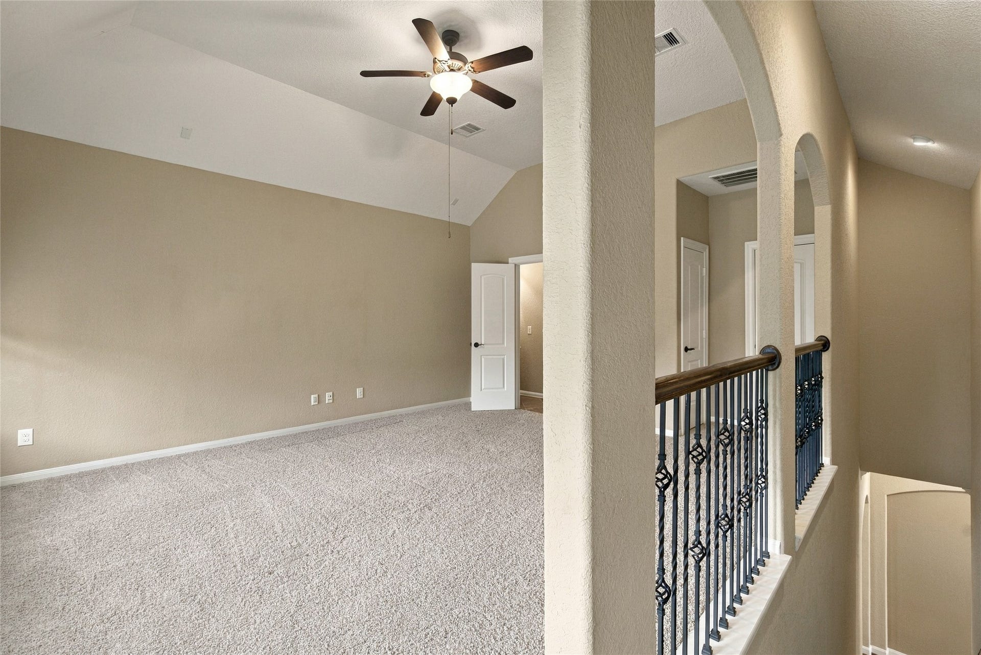 19215 Shady Blossom Drive, Cypress, TX 77433 Versatile upstairs bonus room featuring plush carpeting, a ceiling fan, and an open layout. This spacious retreat is perfect for a game room or additional living space.