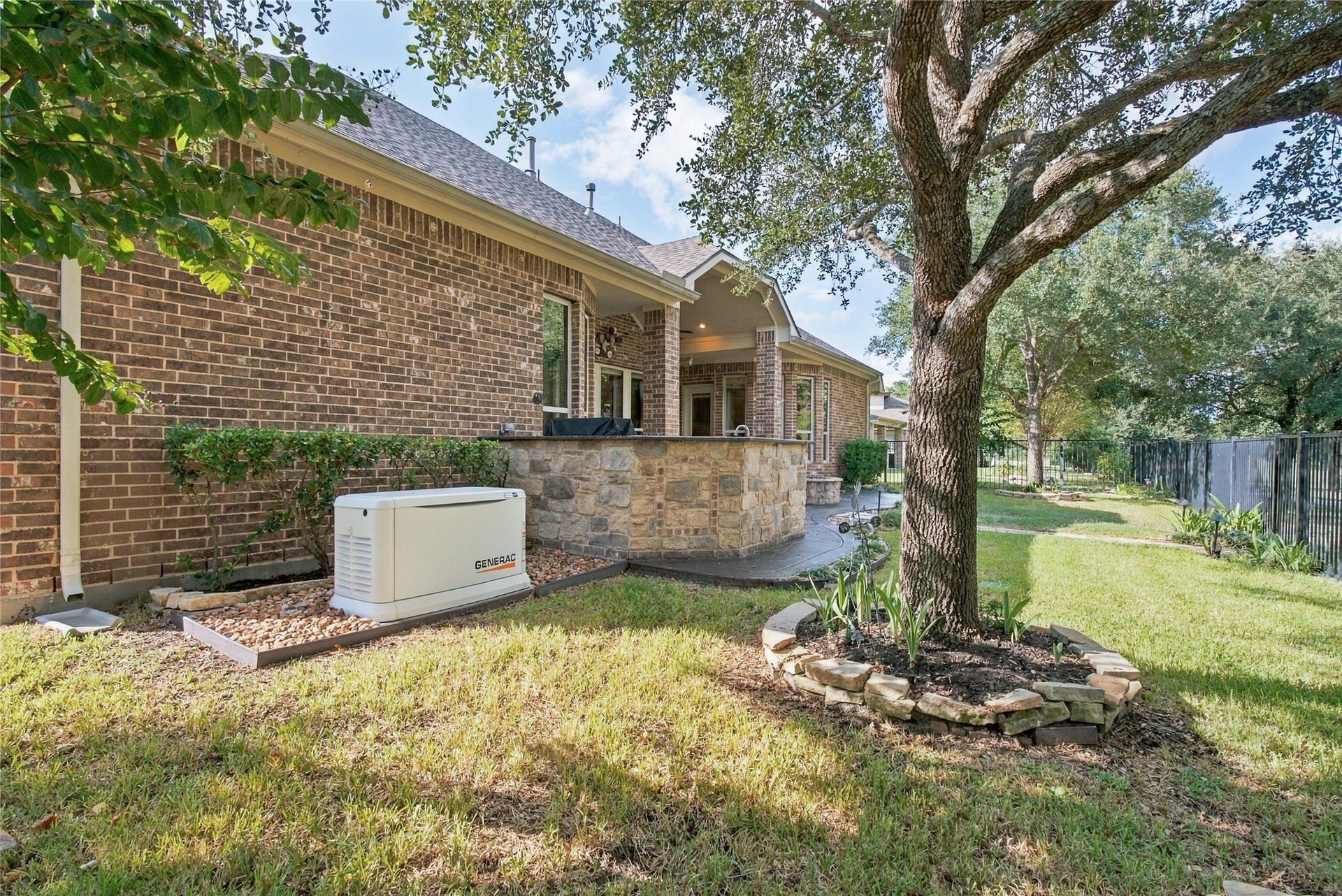 19215 Shady Blossom Drive, Cypress, TX 77433 Additional backyard view highlighting the attractive landscaping, outdoor entertaining space, and whole-home generator.