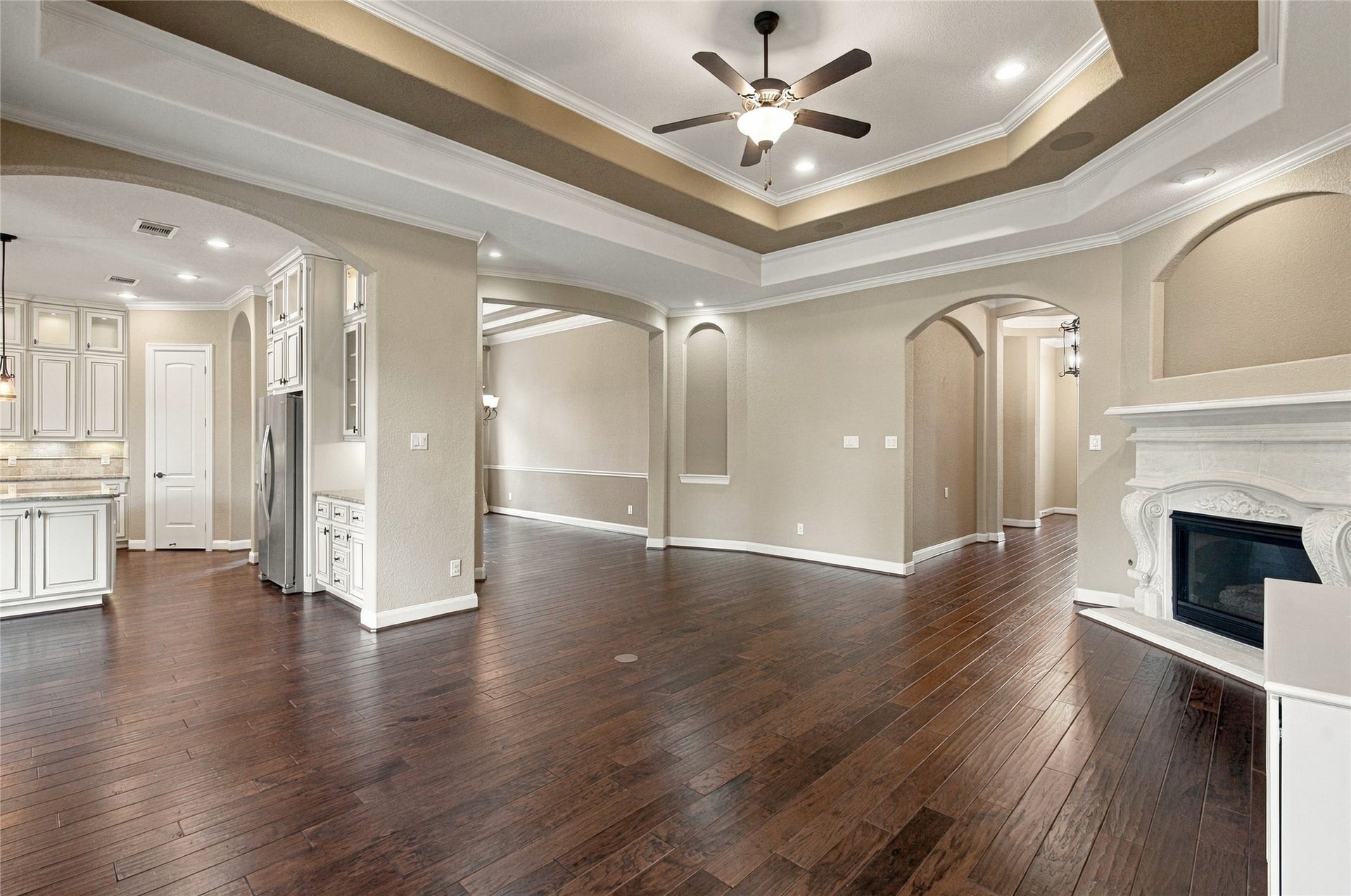 19215 Shady Blossom Drive, Cypress, TX 77433 Bright and welcoming living space featuring high ceilings, wood flooring, and easy access to the kitchen and dining areas.
