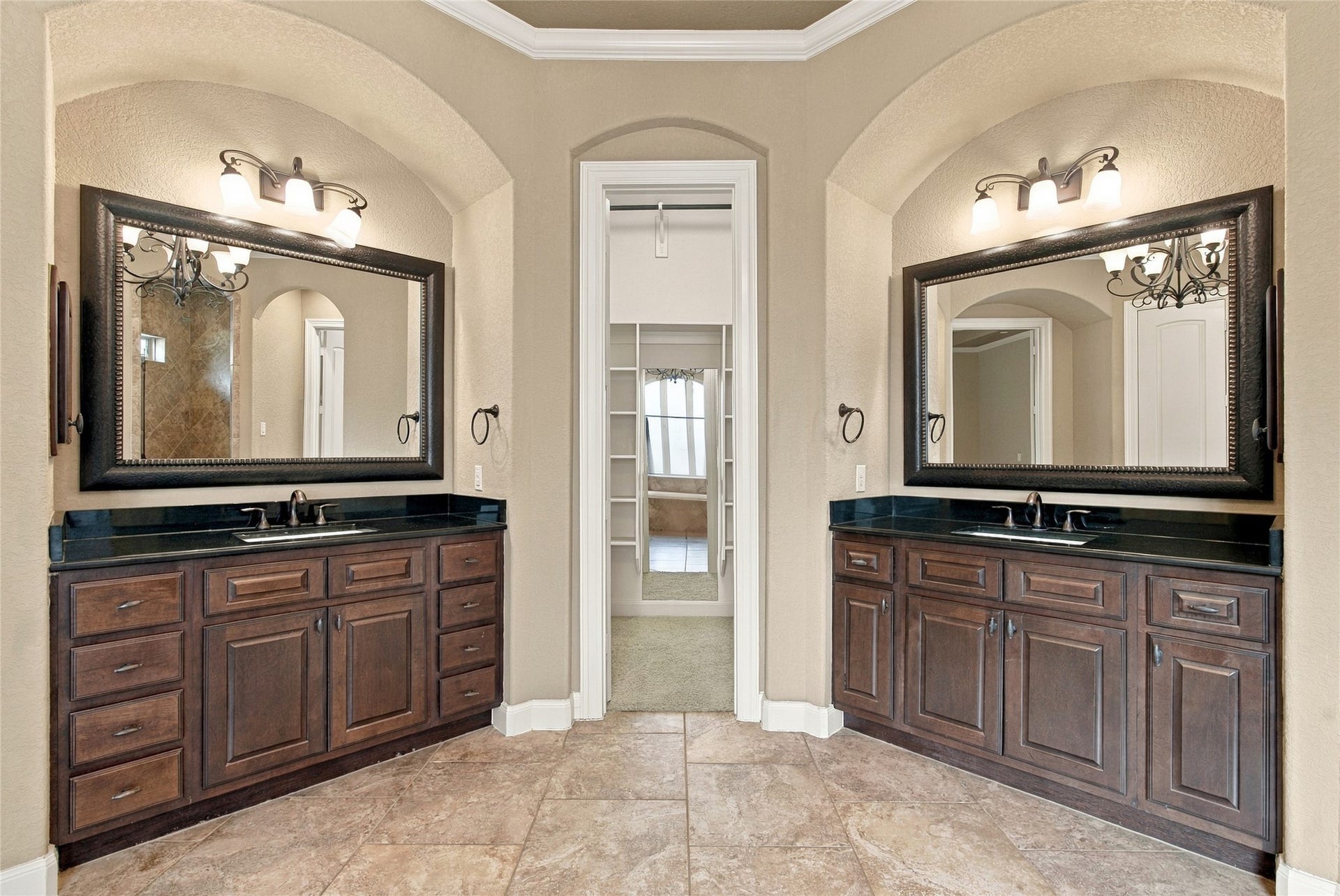 19215 Shady Blossom Drive, Cypress, TX 77433 Spacious primary ensuite featuring separate granite-topped vanities, framed mirrors, and convenient access to the walk-in closets.