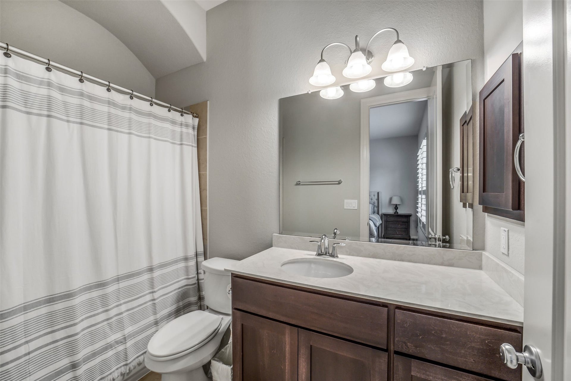 2721 Saddlehorn Trail, Katy, TX 77494 This private en-suite bathroom offers a large vanity with plenty of counter space, abundant storage, and a full bath shower combo.