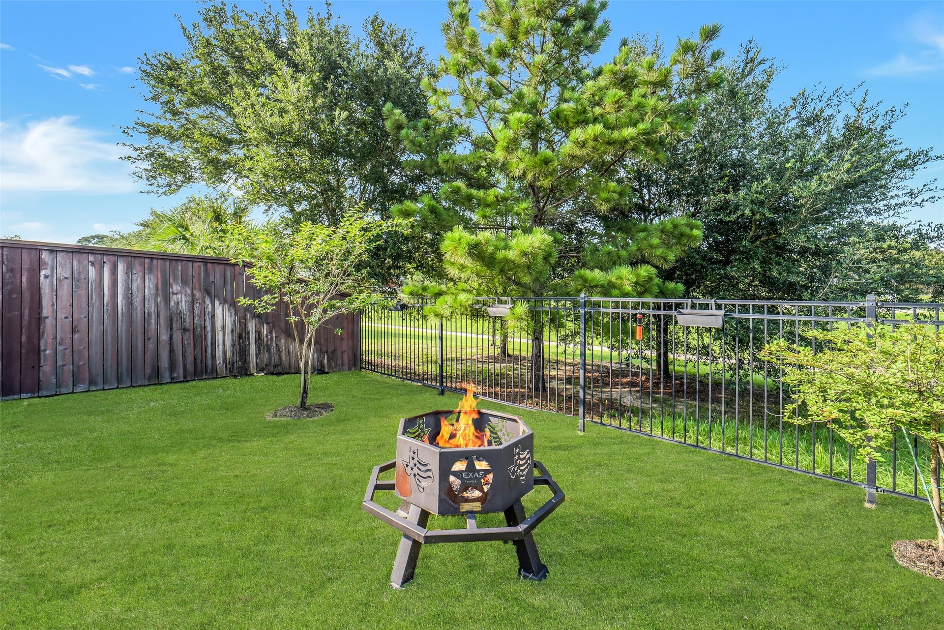 2721 Saddlehorn Trail, Katy, TX 77494 Beautifully landscaped backyard with lush green space, mature trees, and plenty of room to relax, build a pool, entertain, and enjoy evenings around the firepit.