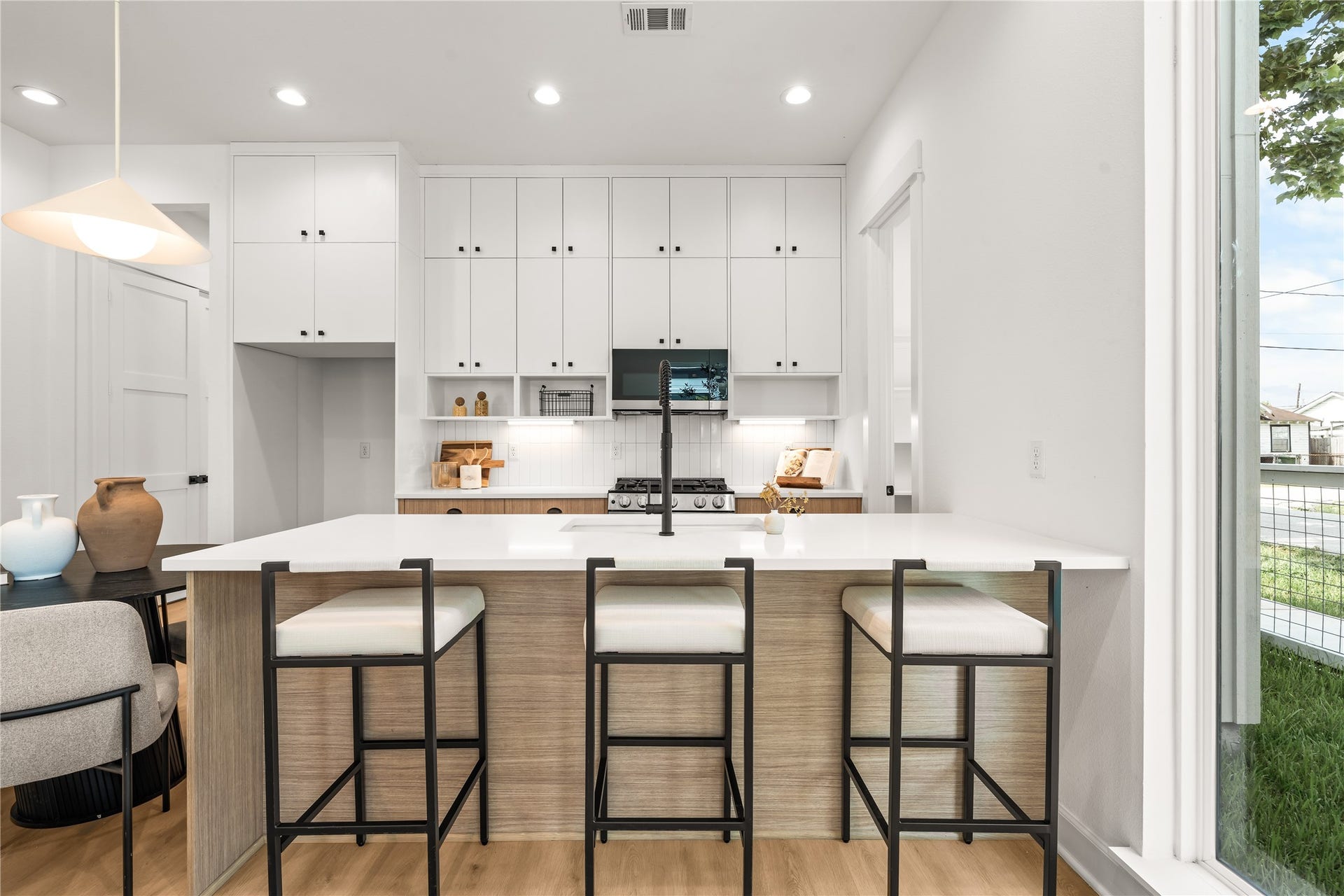 7432-7444 Tremper Street, Houston, TX 77020 Kitchen island with breakfast bar seating the anchor of a main floor built for real life