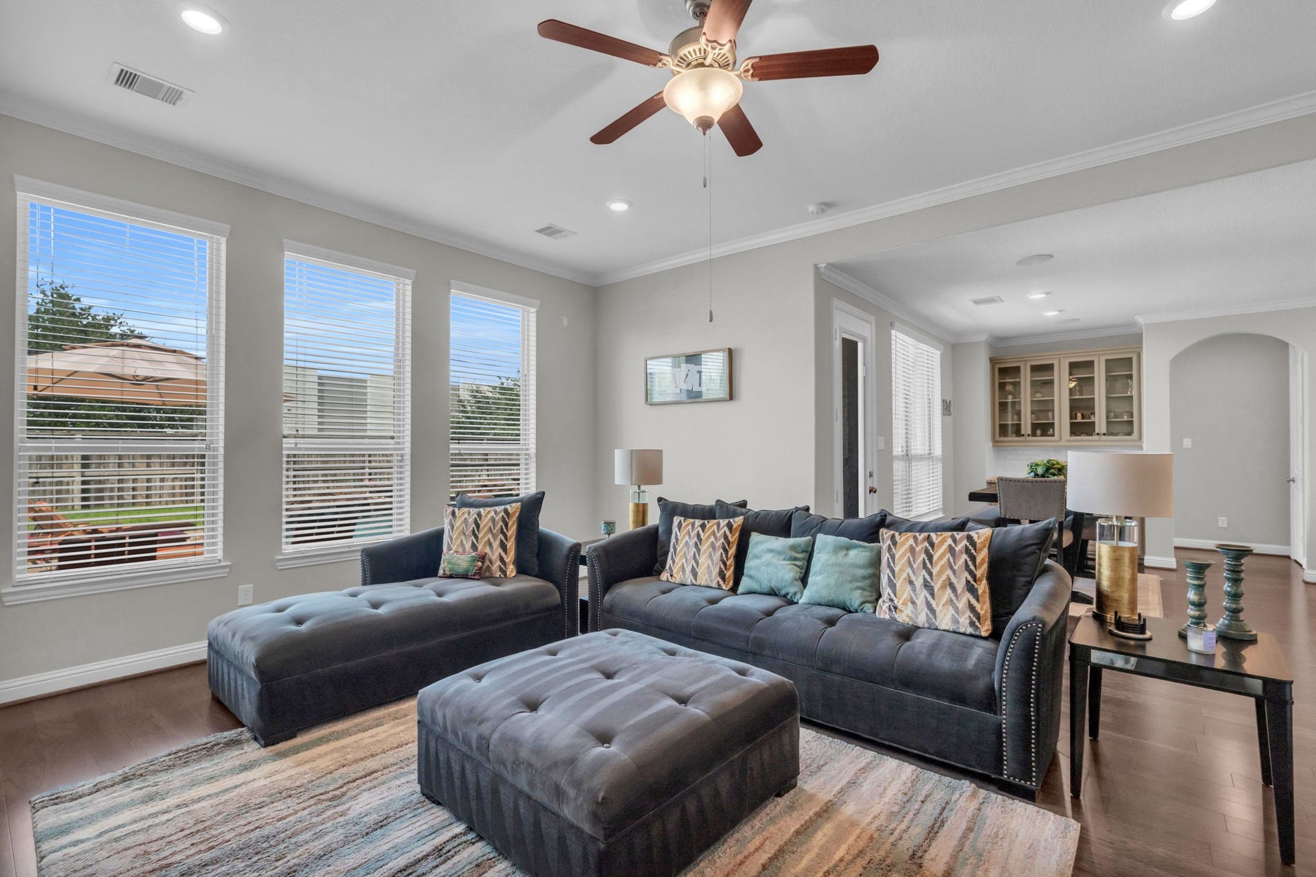 Additional view of this living room, filled with natural light from the large windows.