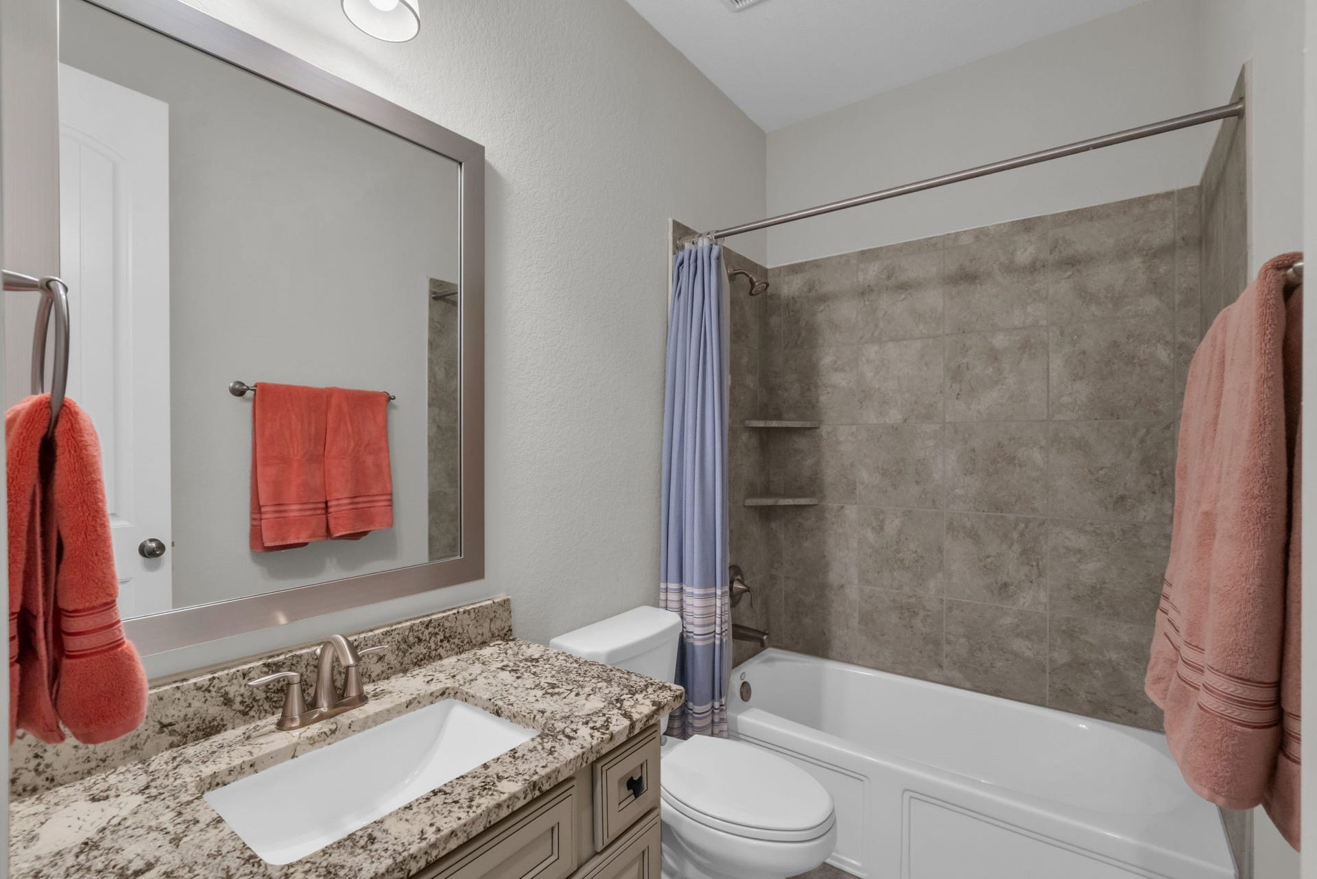 Downstairs secondary bathroom with a combination tub and shower.
