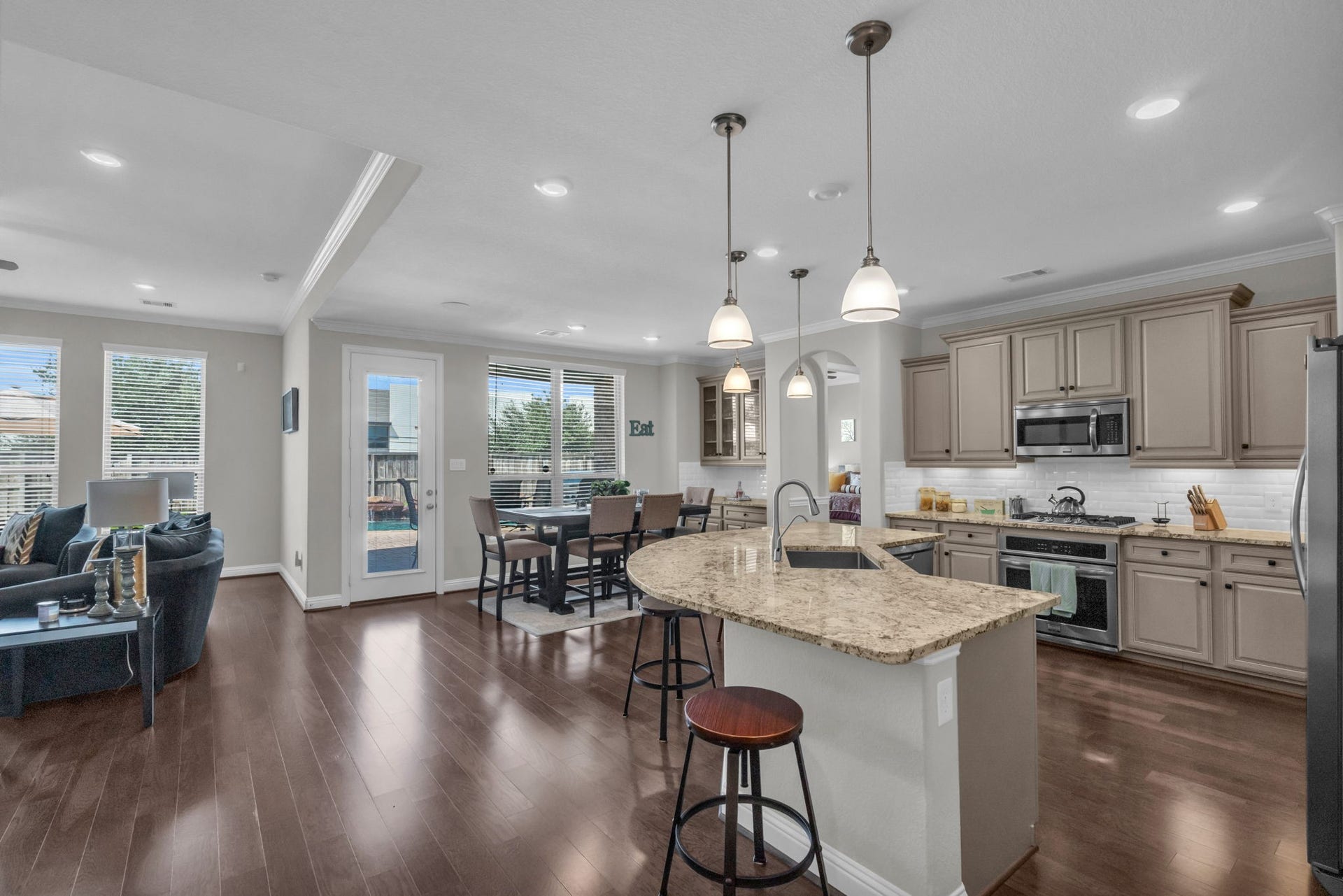 Full look at the open floorplan of the kitchen, breakfast nook, and living room.