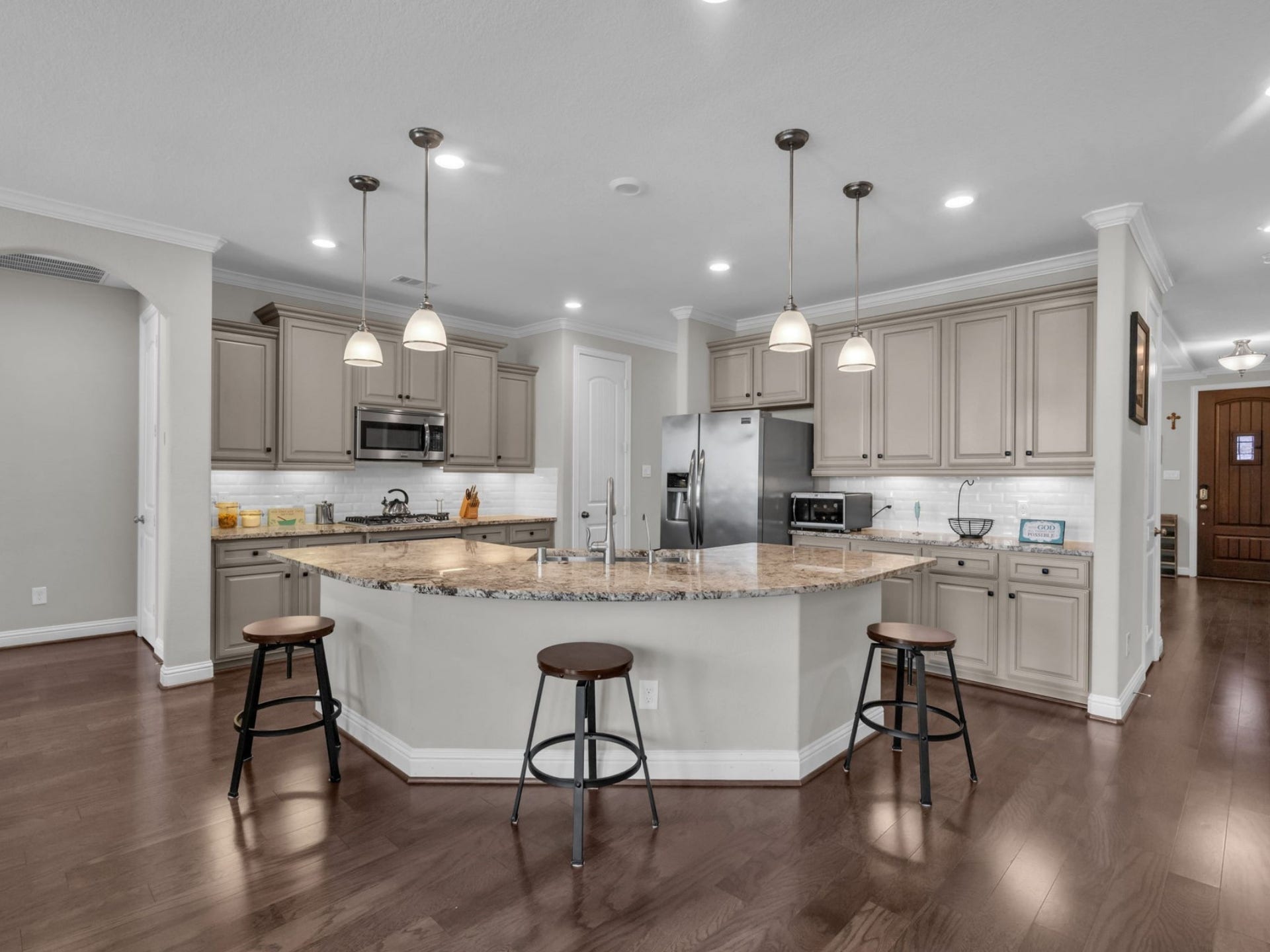 Chef's DREAM kitchen presents beautiful granite countertops, a modern backsplash, and ample storage space!