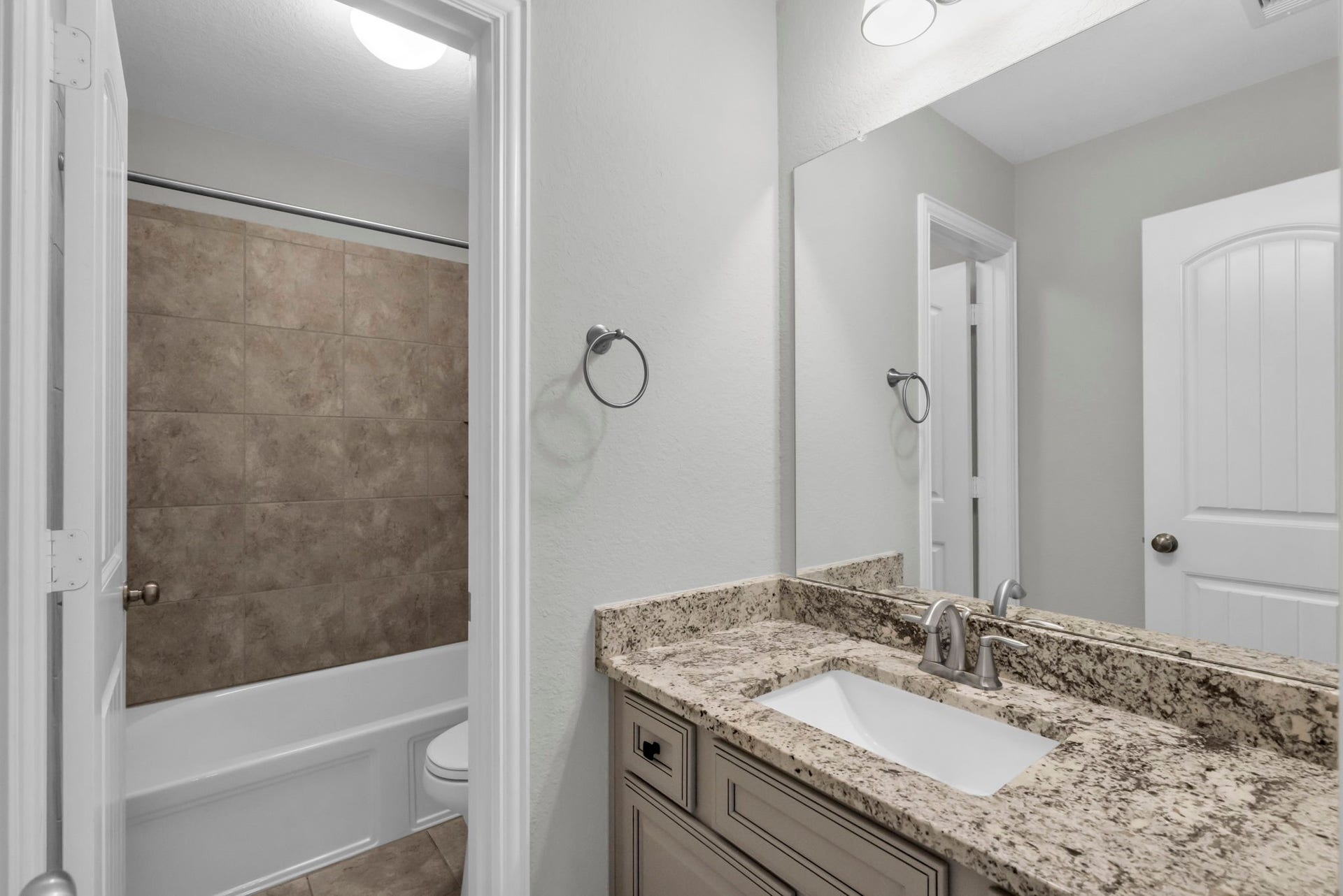 Upstairs secondary bathroom with a combination tub and shower.