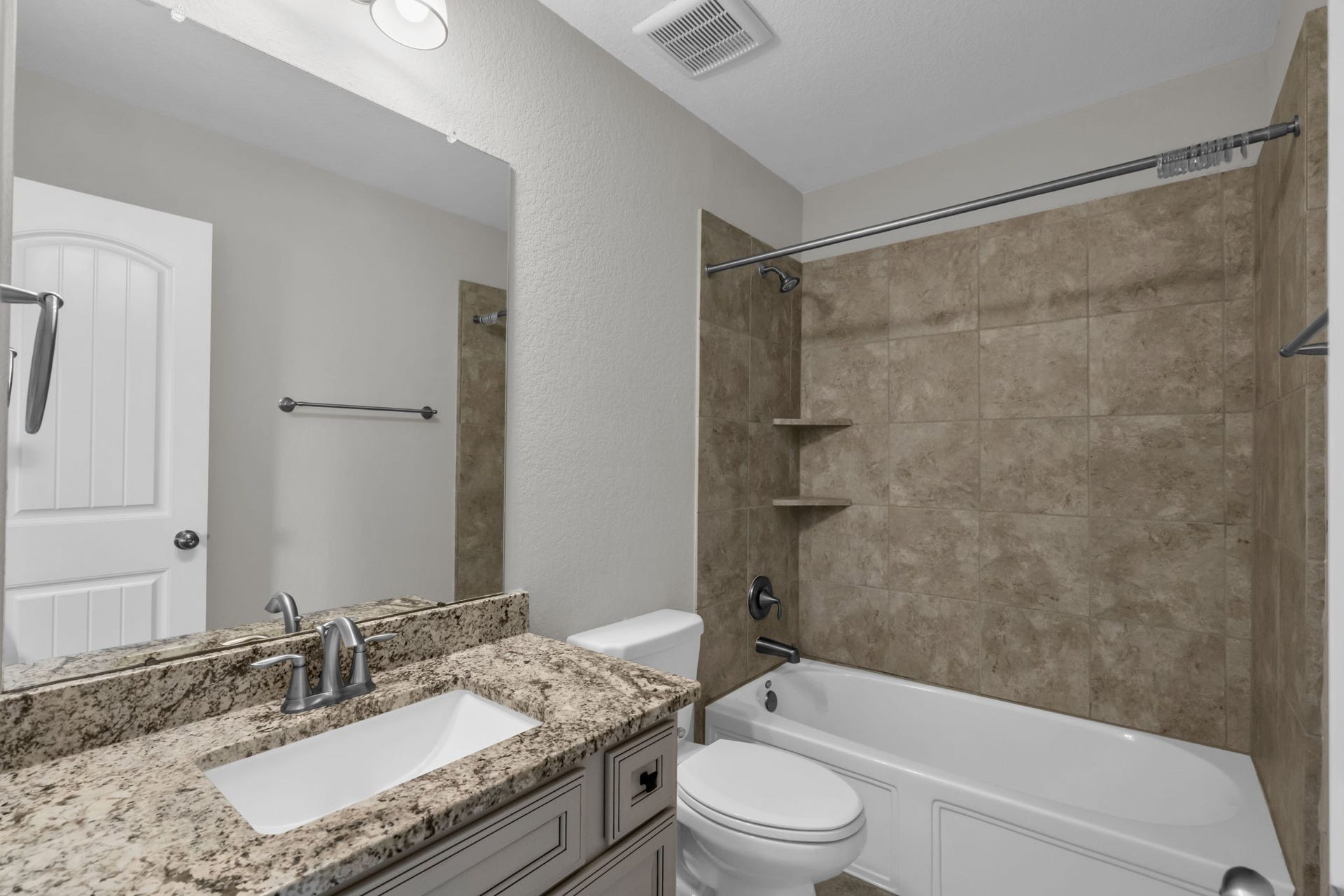 Private en suite bathroom off the upstirs secondary bedroom with a combination tub and shower.