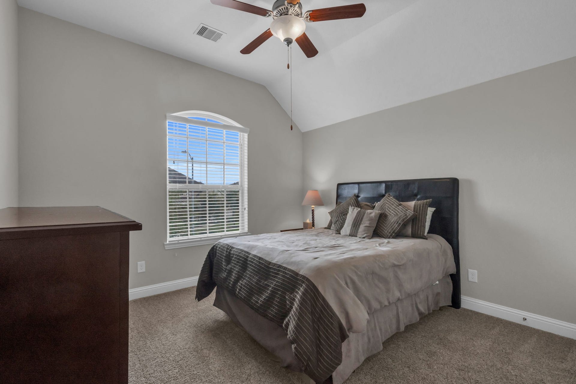 Upstairs secondary bedroom overlooking the front yard and a walk-in closet.