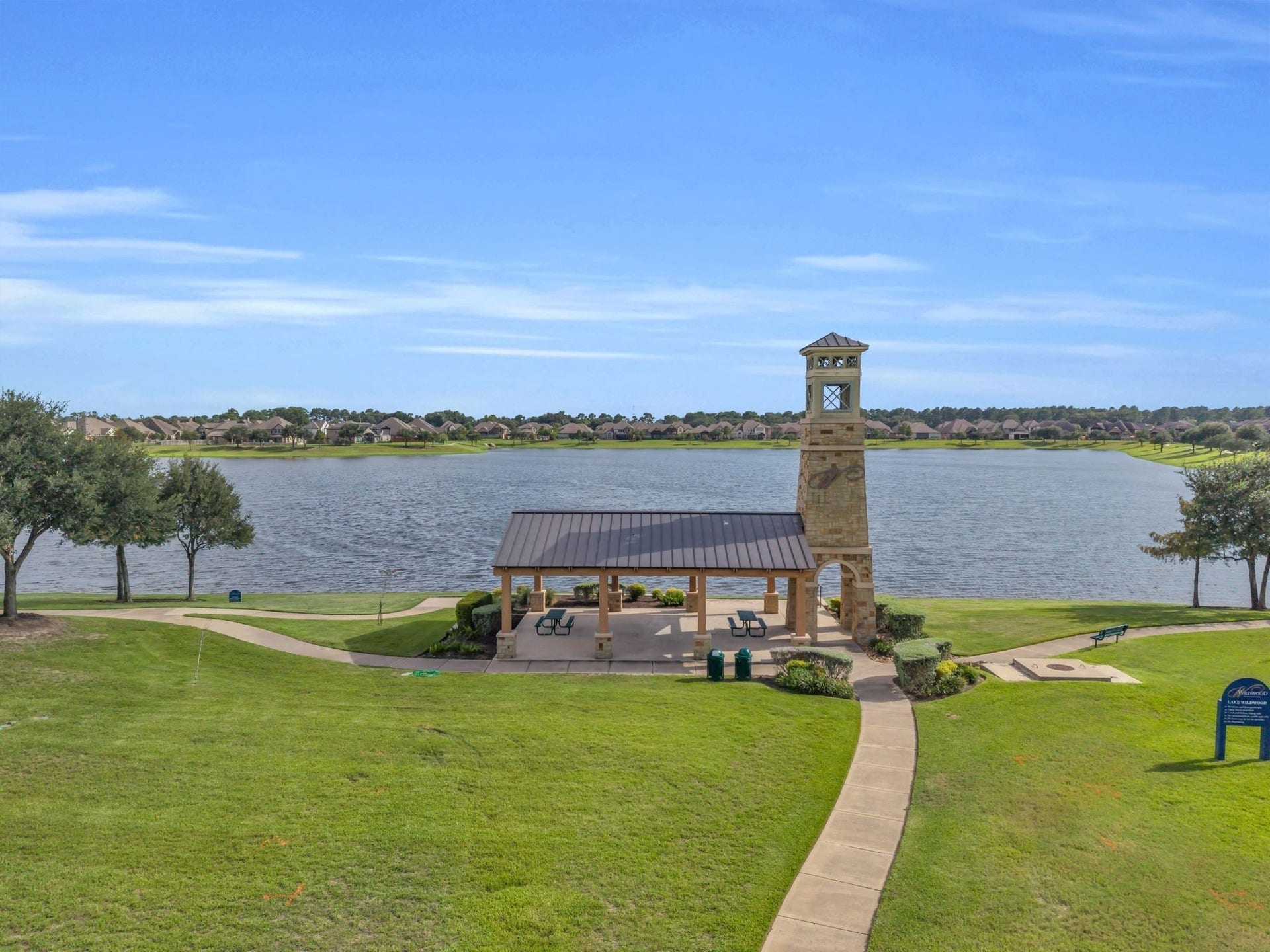 Fabulous community lake features a covered pavilion, walking trails, benches, and beautifully maintained green space.