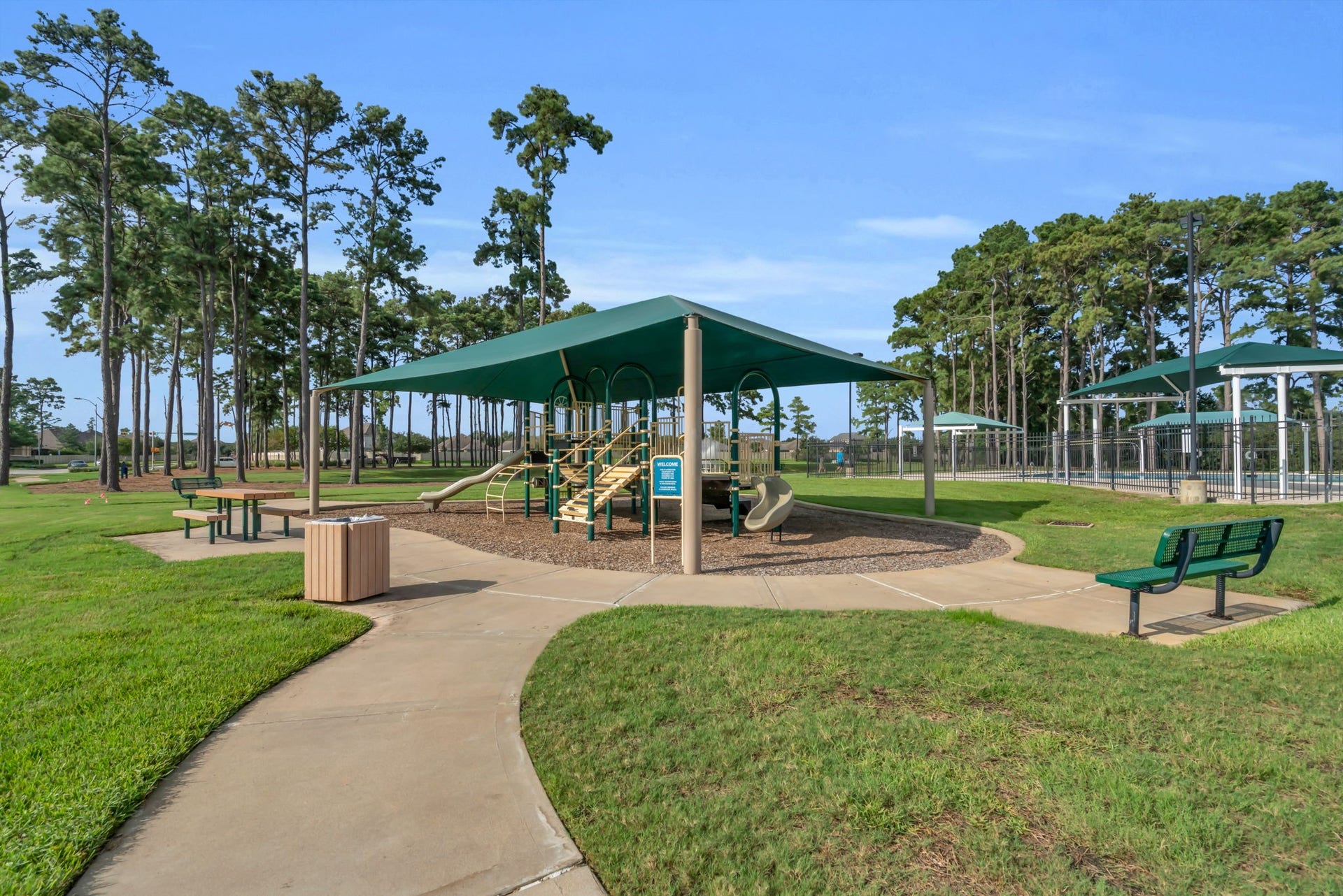 Shaded community park with seating.