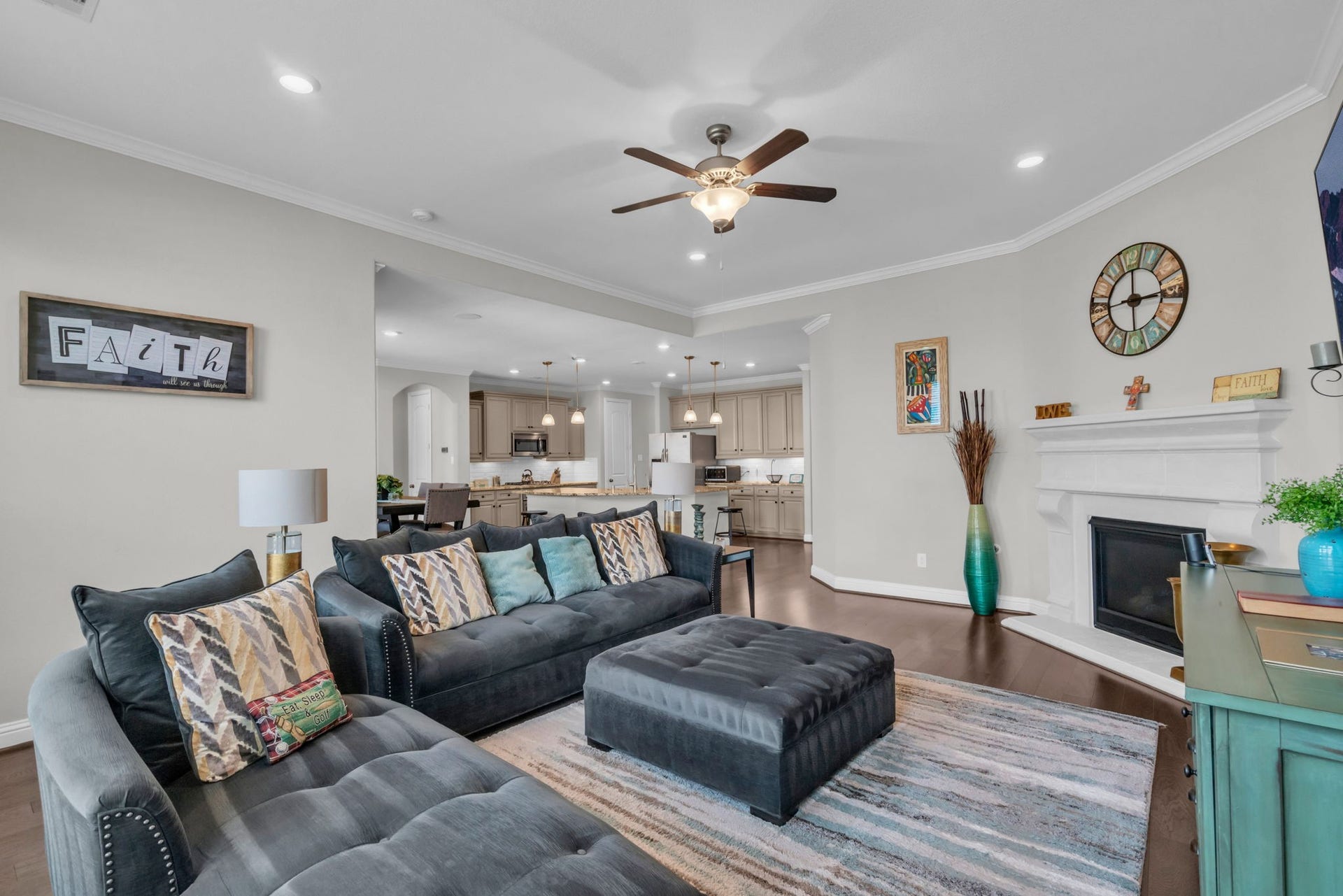 This living room flows seamlessly into the kitchen, creating an open-concept layout.