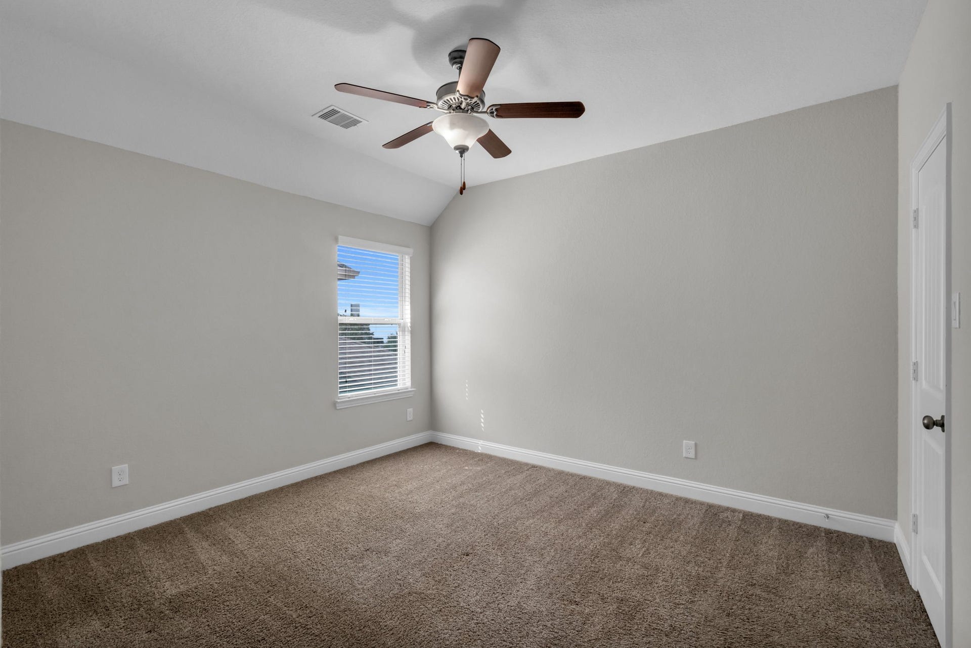 Another upstairs secondary bedroom with a walk-in closet and private en suite.