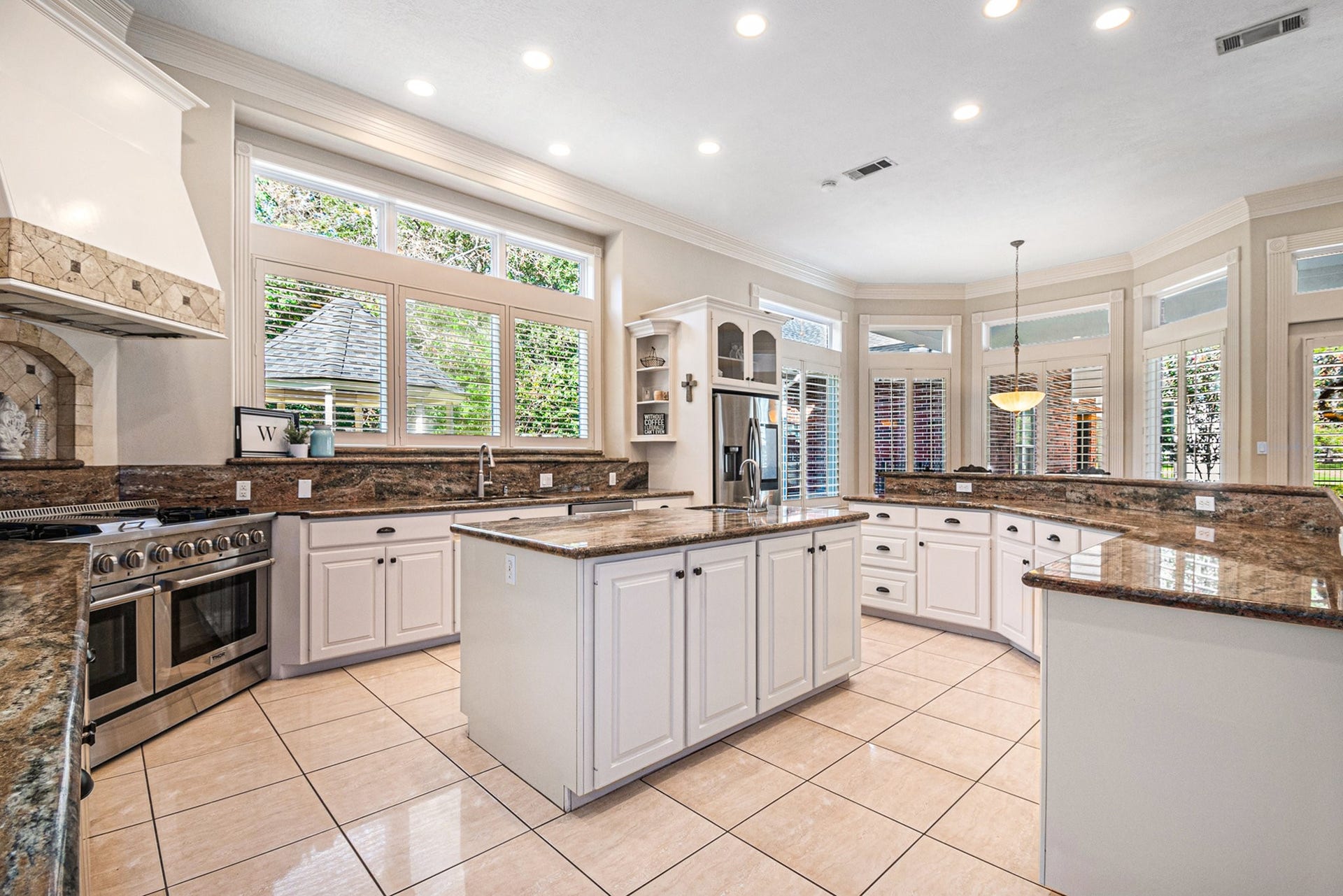 28126 Indigo Lake Court, Magnolia, TX 77355 Chef's DREAM kitchen showcases granite countertops, a massive island with an extra sink, and ample breakfast bar seating.