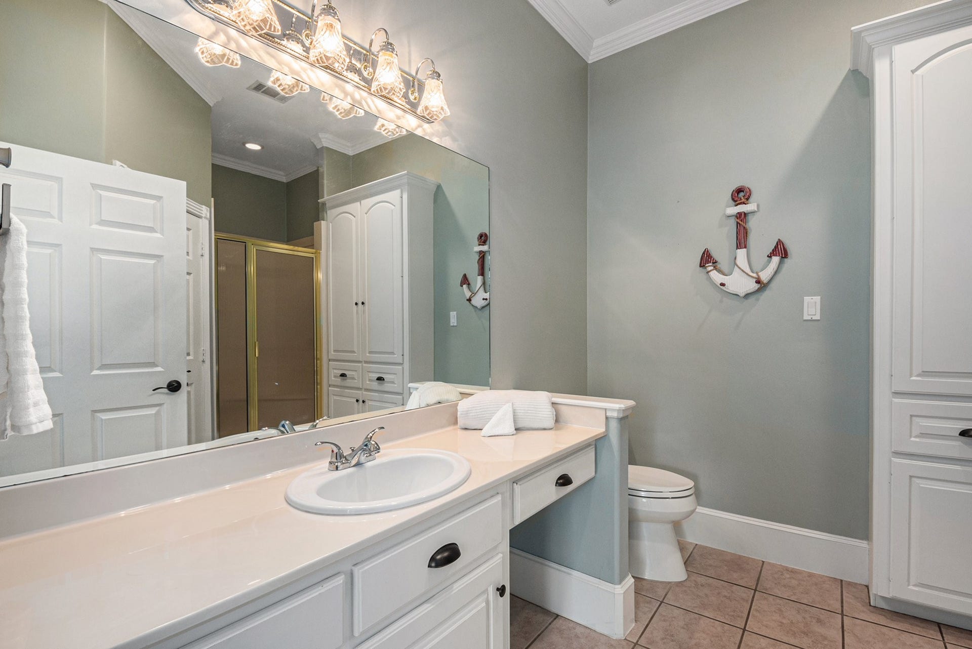 28126 Indigo Lake Court, Magnolia, TX 77355 This secondary bathroom in the guest house offers a glass-standing shower, vanity seating, and lots of storage space.