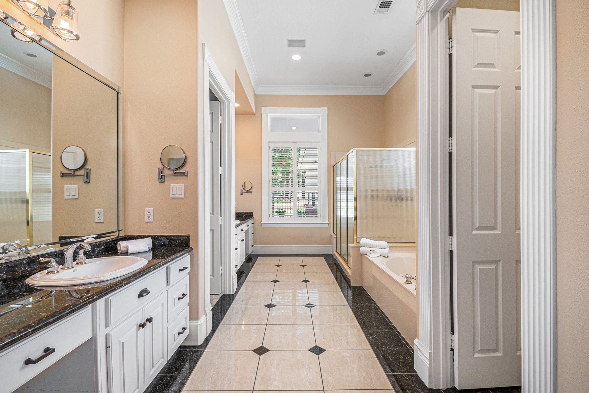 28126 Indigo Lake Court, Magnolia, TX 77355 Magnificent primary bathroom features dual vanities with vanity seating, a glass-standing shower, a soaking tub, and a massive walk-in closet.