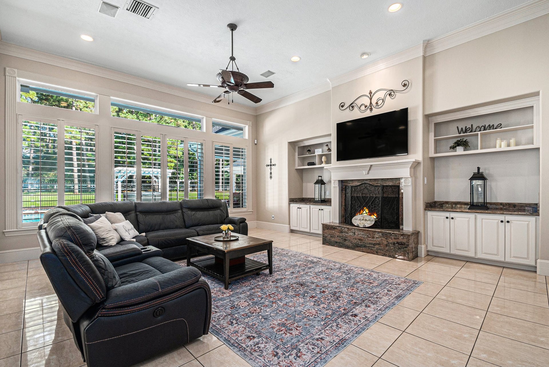 28126 Indigo Lake Court, Magnolia, TX 77355 The spectacular main living room presents high ceilings, gorgeous built-ins, a cozy fireplace, and great views of the backyard.