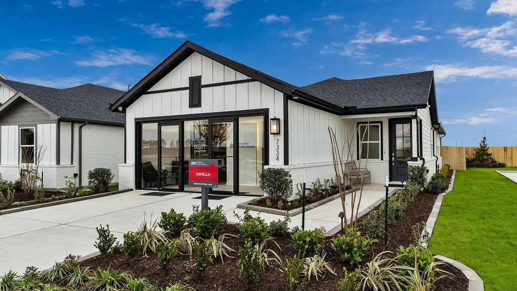 7334 Grand Mason Drive, Cypress, TX 77433 Modern facade is perfection with thoughtfully selected designer colors and materials, and the result is stand out home! Modern wall lantern highlights the floating address numbers and walkway to front entry. Landscaped beds add softness and vibrant color.