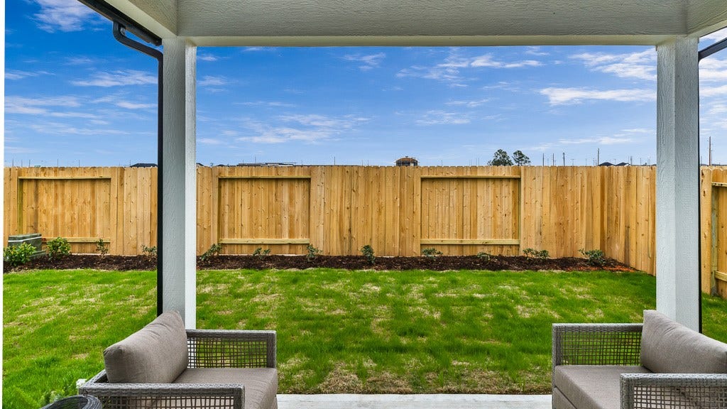 7334 Grand Mason Drive, Cypress, TX 77433 Gorgeous backyard has a good-neighbor fence with landscaped bed and covered lanai.