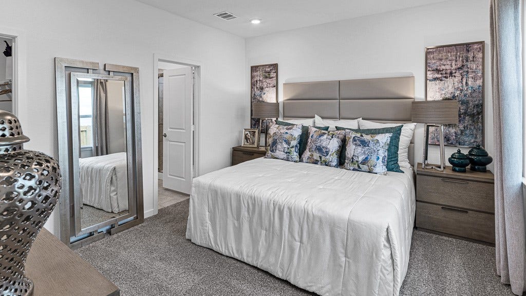 7334 Grand Mason Drive, Cypress, TX 77433 Primary suite has an inviting presence with understated sophistication by designer white walls, and beautiful warm gray premium carpeting.