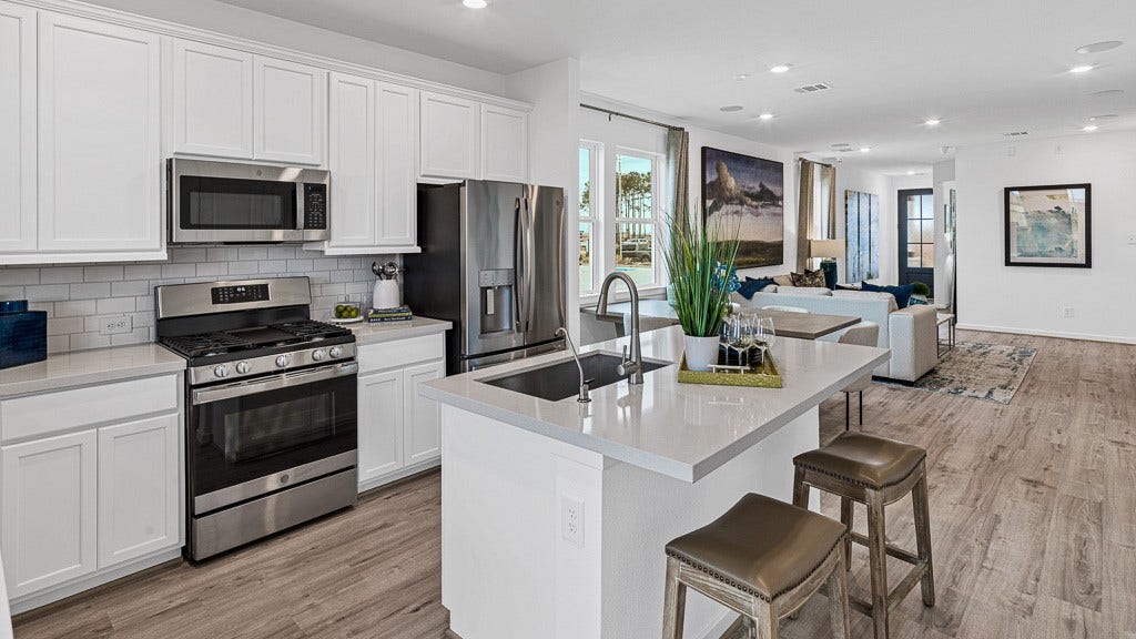 7334 Grand Mason Drive, Cypress, TX 77433 Island has stainless steel sink with modern fixtures, filtered water faucet, dishwasher and room for seating.
