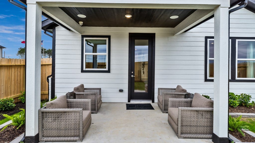 7334 Grand Mason Drive, Cypress, TX 77433 Black slatted ceiling with recessed lighting and black full lite glass door add high end style to this home.