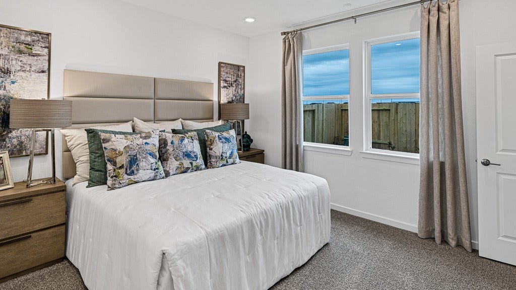 7334 Grand Mason Drive, Cypress, TX 77433 Primary suite has beautiful windows with views of backyard and elegant custom drapery.
