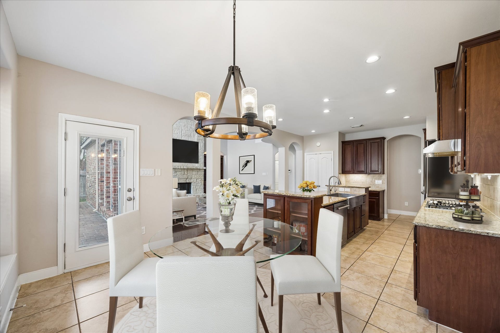 2902 Grand Mesa Pass, Missouri City, TX 77459 Stylish details give the breakfast area and kitchen a little extra polish, from the chandelier over the casual dining space to the glass front cabinets at each end of the oversized island. It's functional and definitely not boring.