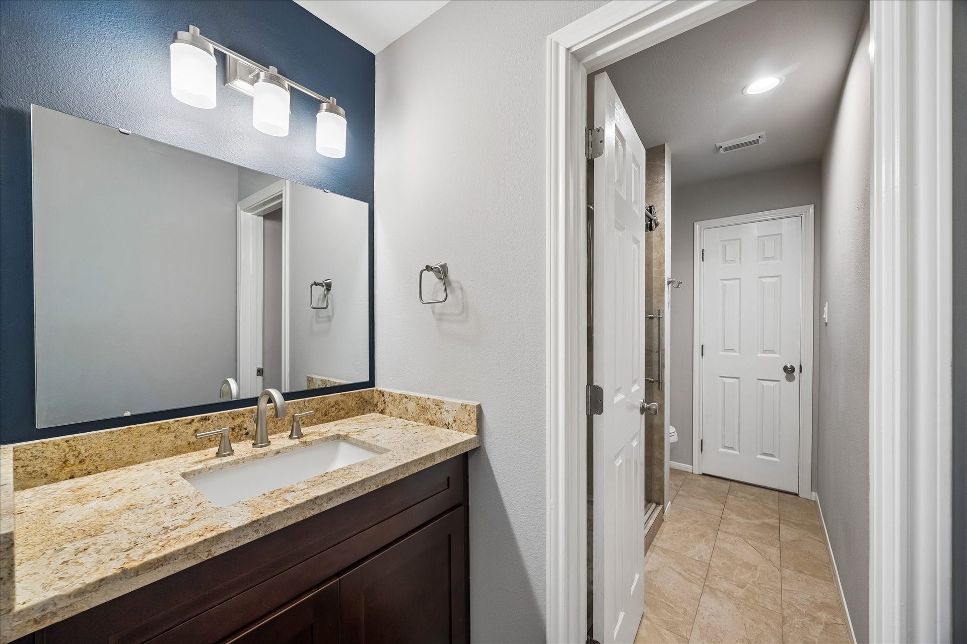 2902 Grand Mesa Pass, Missouri City, TX 77459 This Hollywood bath adds everyday convenience with a private vanity area and a shared water closet featuring a sleek frameless glass walk in shower. It is a smart setup that helps busy mornings run a little smoother.