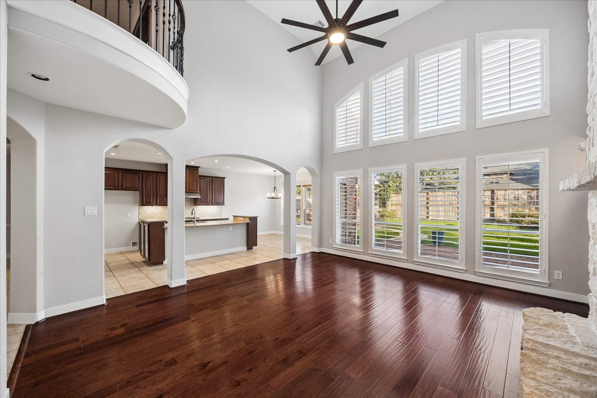 2902 Grand Mesa Pass, Missouri City, TX 77459 Stacked windows with wood shutters frame picture perfect backyard views and fill this family room with natural light. There is plenty of space to spread out, relax and settle in, whether it is a quiet night at home or a full house of guests.
