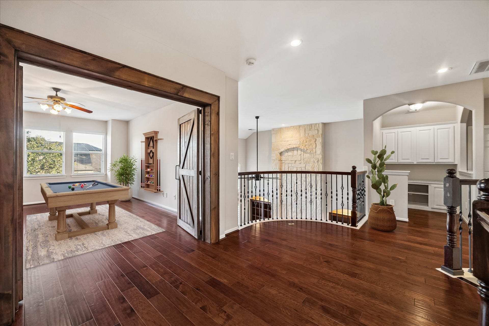 2902 Grand Mesa Pass, Missouri City, TX 77459 Custom rustic barn doors give this upstairs game room a little extra personality and plenty of flexibility. Keep it open to the landing for an easy flow or close it off when the fun gets a little louder.