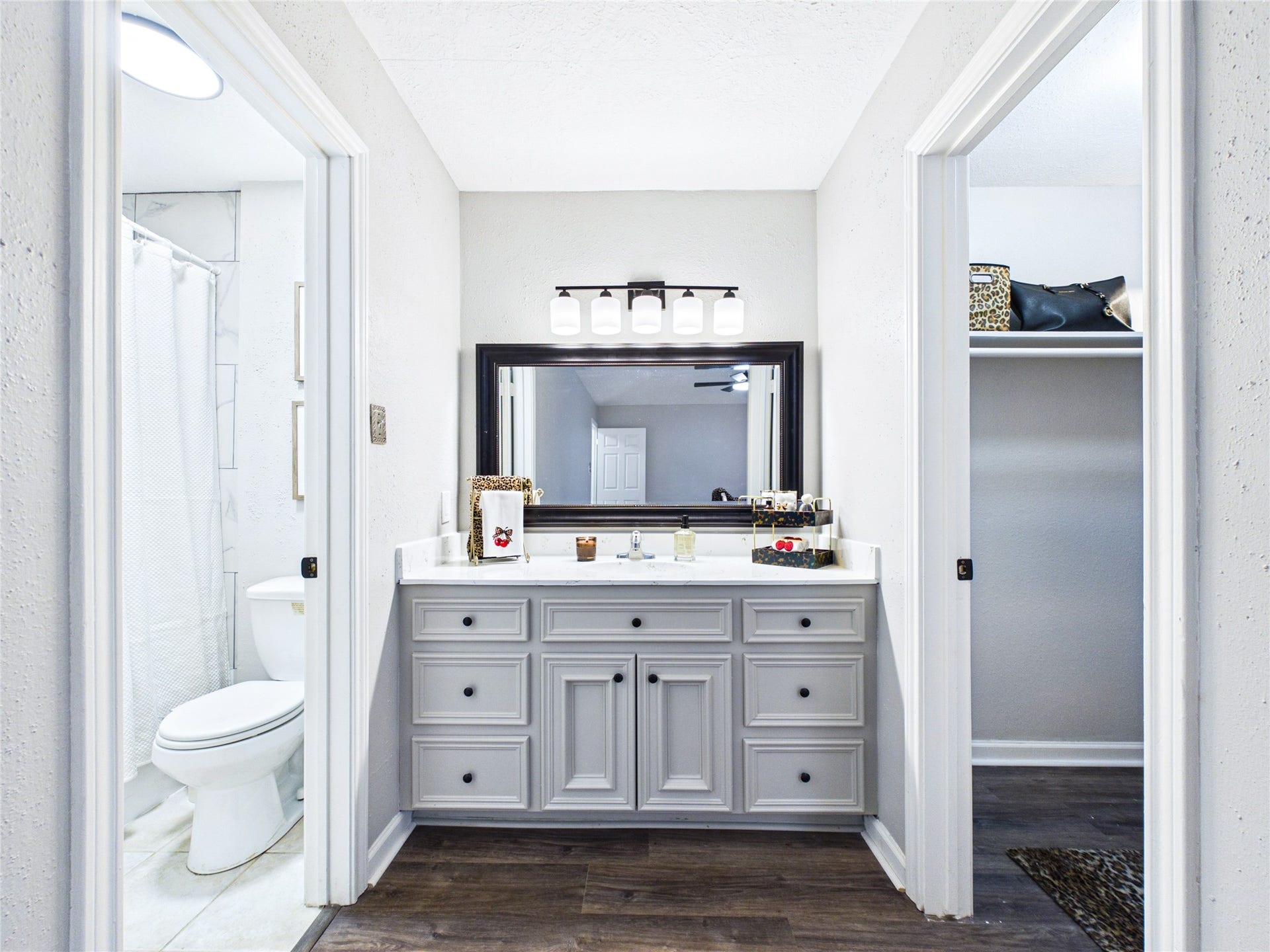 6209 Brookdale Drive, League City, TX 77573 Beautiful Primary bathroom with a sleek vanity, modern lighting, and convenient access to a walk-in closet on the right and a bright shower area on the left.