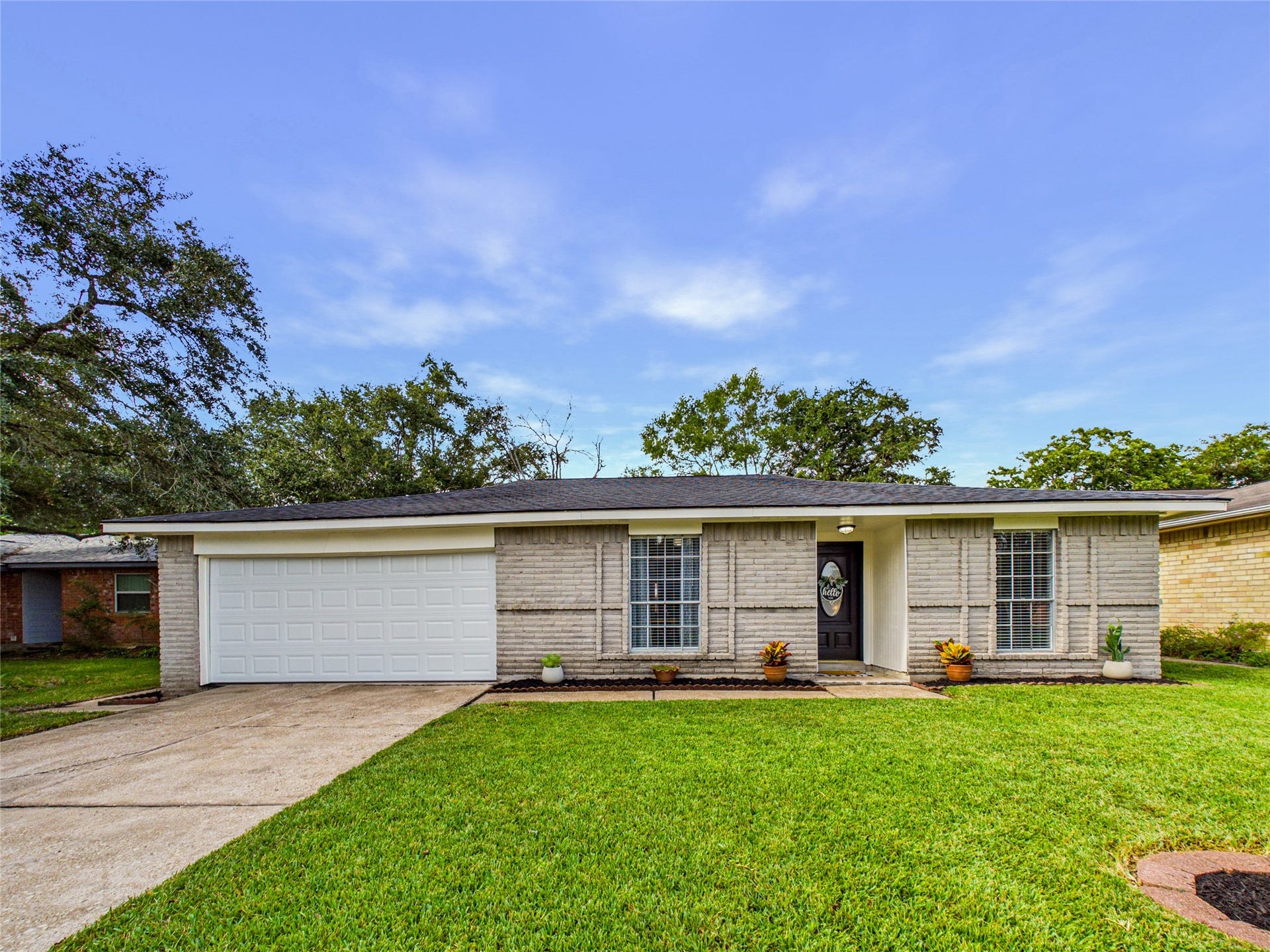 6209 Brookdale Drive, League City, TX 77573 Charming single-story home with a welcoming facade, featuring a spacious two-car garage and a well-maintained.