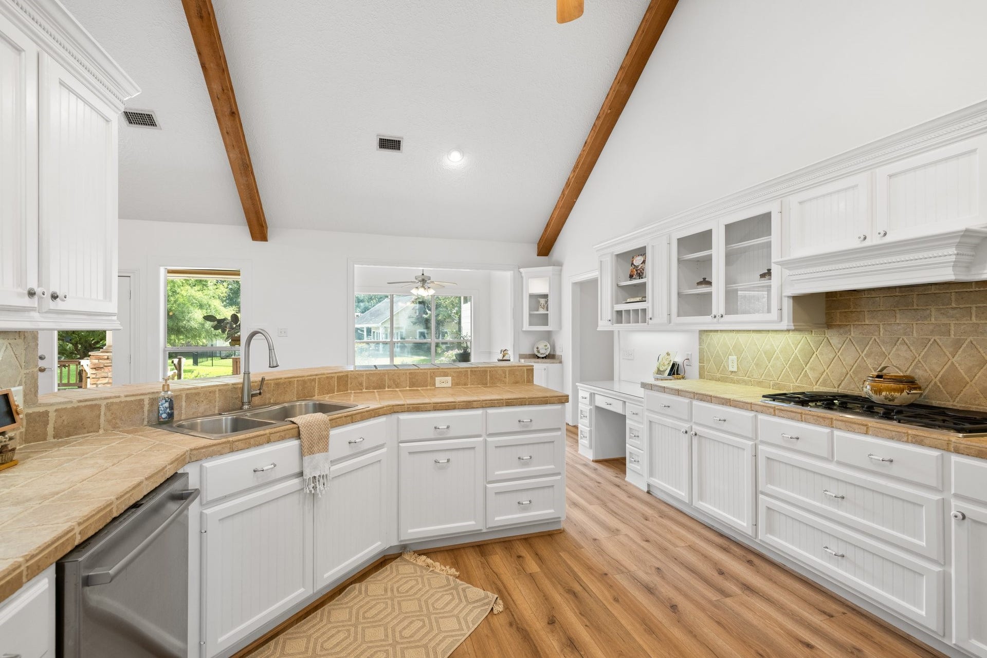 34310 High Point Drive, Magnolia, TX 77355 This kitchen features abundant cabinets for storage, expansive counters for meal prep, and a convenient desk for organizing recipes or handling bills.