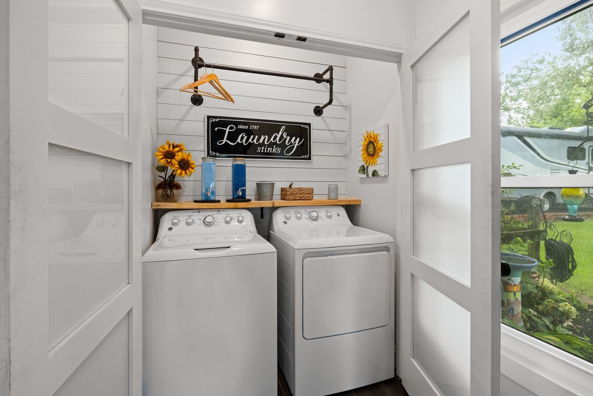 34310 High Point Drive, Magnolia, TX 77355 This cozy laundry room features a perfect place for your washer and dryer, decorative shelving, and an accent wall. The space is bright and functional, with charming accents like a hanging rod for a welcoming touch