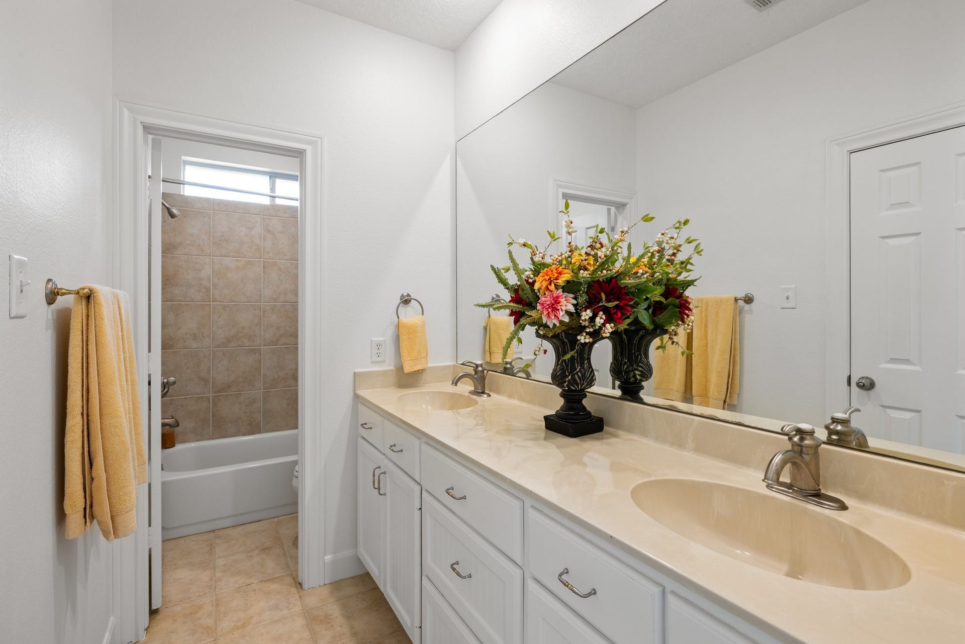 34310 High Point Drive, Magnolia, TX 77355 Generous ensuite bath enhances the secondary bedroom. Complete with double sinks, plenty of counters space and cabinets for storage.