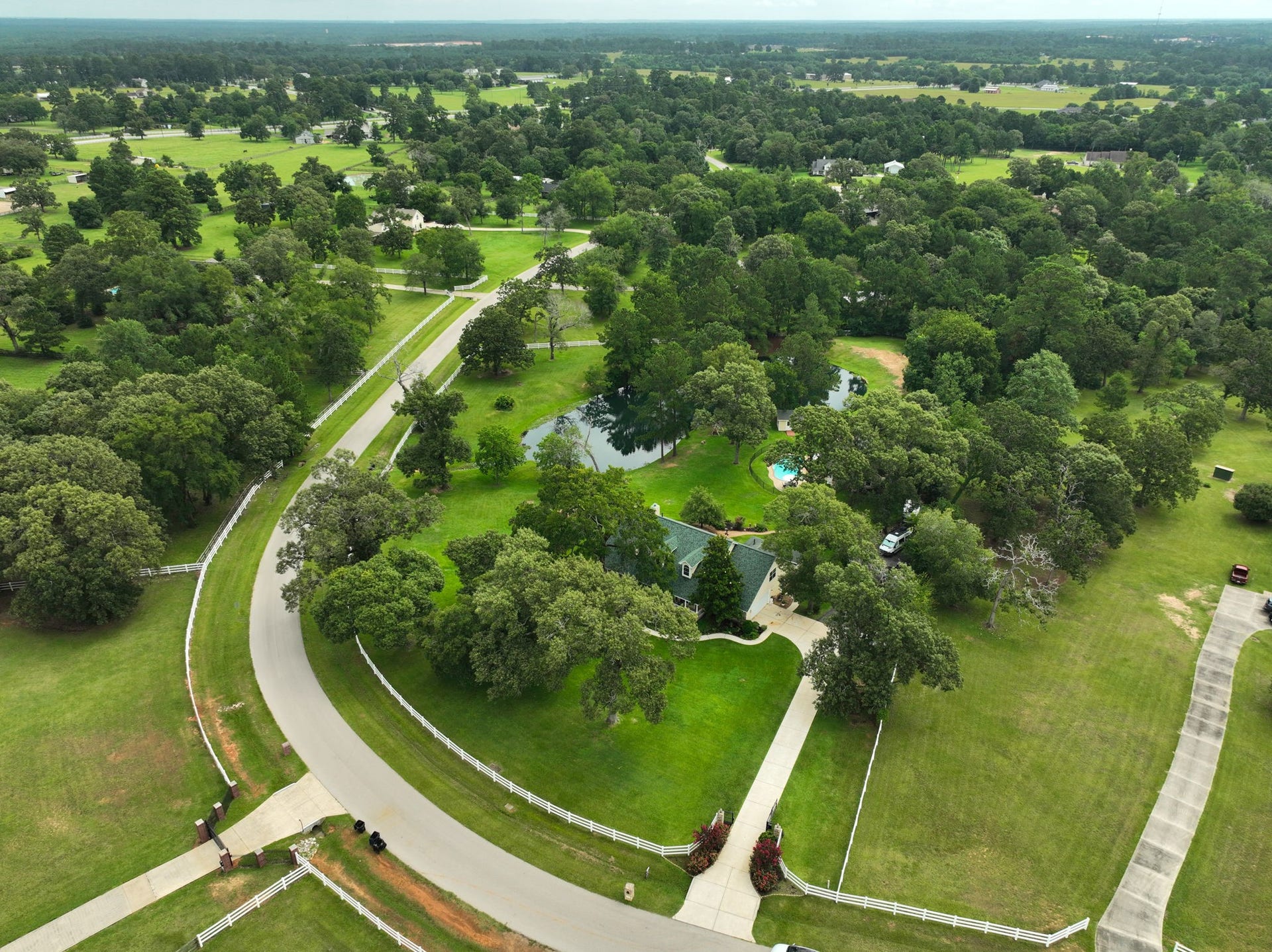 34310 High Point Drive, Magnolia, TX 77355 Stunning aerial view showcasing the sprawling layout and natural beauty of the property.