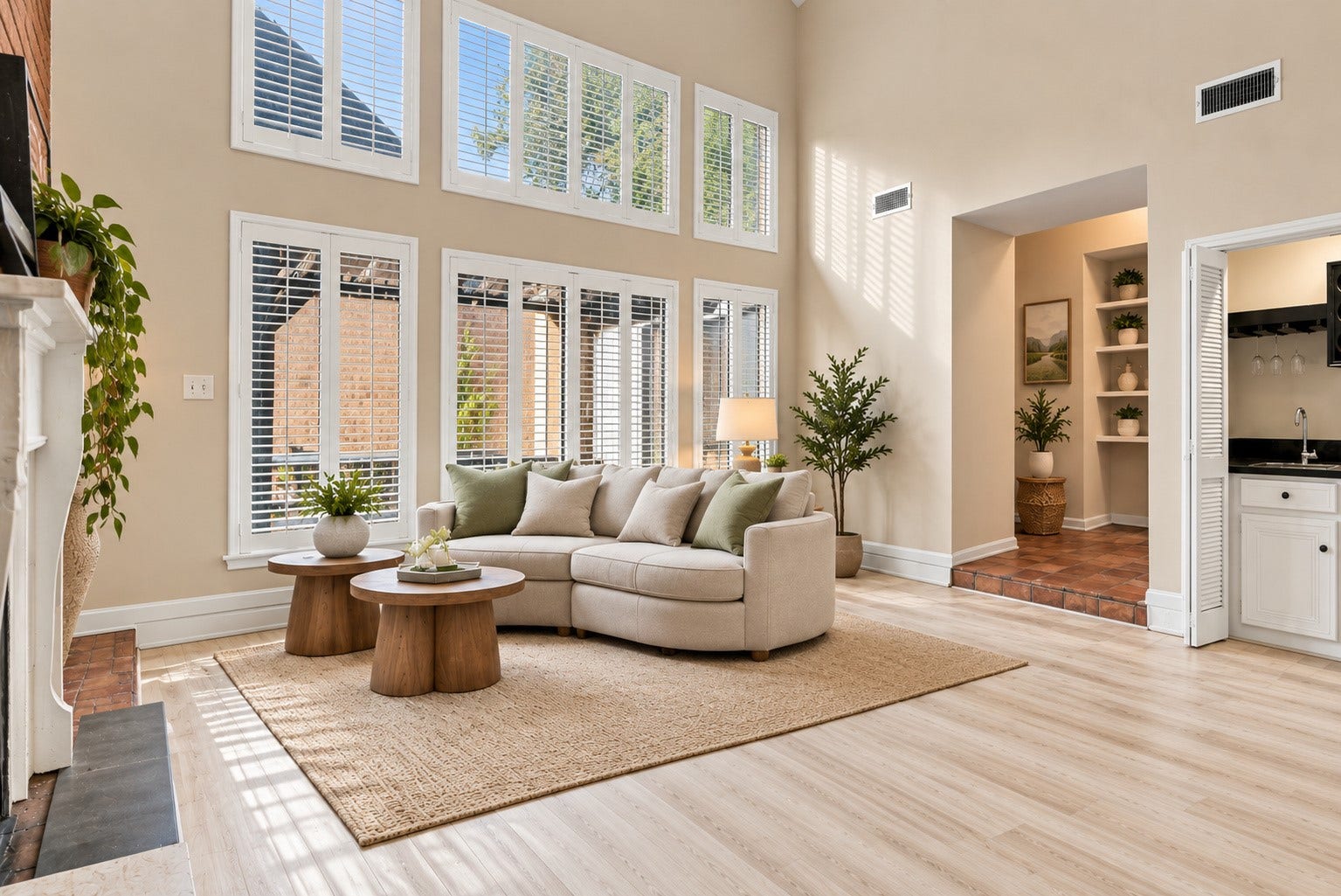 Virtually staged living room featuring soaring ceilings, dramatic windows, and a comfortable seating arrangement.